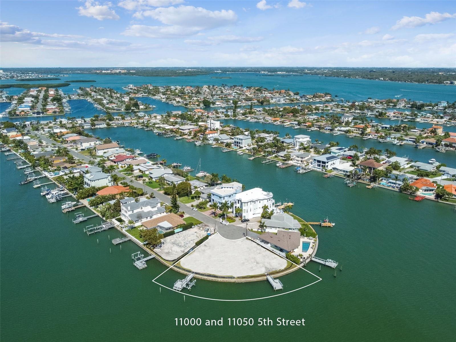 Under contract-accepting backup offers. A truly rare offering in the highly coveted Isle of Palms neighborhood, this exceptional double bayfront homesite presents a once-in-a-lifetime opportunity to create a custom waterfront estate in one of Treasure Island’s most desirable locations.

Spanning approximately 0.36 acres, this oversized corner lot boasts an impressive 208 feet of seawall, delivering some of the widest, most unobstructed open water views available. With sweeping western exposure across the Intracoastal Waterway, you’ll enjoy breathtaking panoramic vistas, vibrant sunsets, and daily encounters with Florida’s coastal wildlife.

Positioned on deep, protected water, this property is a boater’s dream. Featuring two existing docks and two boat slips, it offers direct, access to the Gulf, ideal for accommodating larger vessels or creating your own private boaters retreat.

Set at the end of a quiet cul-de-sac and surrounded by some newly built luxury homes, this high-value location offers both privacy and prestige. The beach is a little more than half a mile away, while shopping, dining, and everyday conveniences are just minutes from your doorstep. Enjoy effortless access to the best of coastal living, along with nearby attractions in downtown St. Petersburg and Tampa.

This unique property is the result of combining two separately acquired parcels (11000 & 11050 5th St E), now ready for development. Architectural renderings are already available, offering a vision for a stunning custom residence designed to maximize the expansive water views and exceptional setting.

To help showcase the incredible potential of this property, the owner previously collaborated with a custom builder to design a stunning residence specifically envisioned for the site. Architectural concepts, renderings, and preliminary engineering work was done and renderings have been included as inspiration for what could be built on the property. While buyers are welcome to connect with the owner’s builder, they are under no obligation and may use the builder of their choice to create their own dream home. The listing price is for the lot only. 

Whether you’re a boating enthusiast, a luxury home builder, or a buyer seeking a true trophy property, this is an unparalleled opportunity to build your dream home in a premier waterfront location.