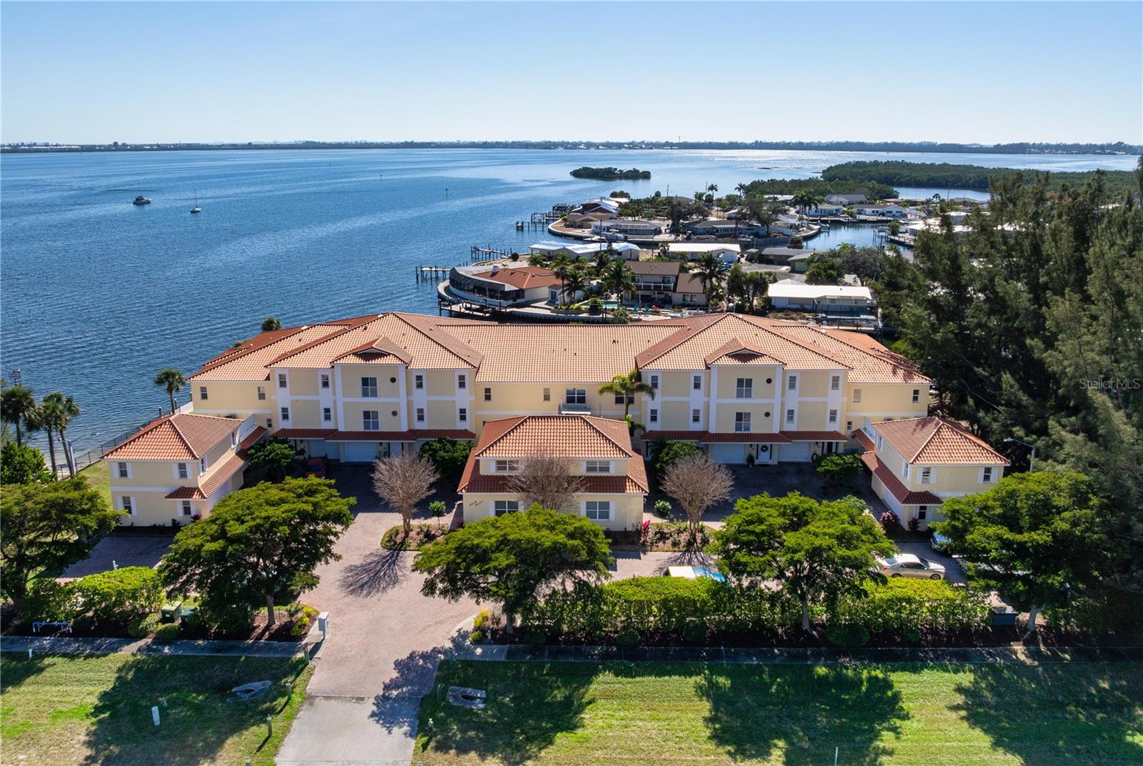Waterfront Living! Embrace the Spectacular and Wide Open Views of Palma Sola Bay and the Intracoastal! This is a Townhouse that lives like a House. This Home is a spacious 3/3 that includes more square footage than what is listed in the square feet living area. It has a Beautiful Chefs Kitchen that was remodeled with Wood Cabinets to the Ceiling and Stone Undercounter Lighted Countertops. The Home also features Marble and Wood Floors, a Master Bathroom with a Large Shower plus a Jacuzzi Tub, and your own Elevator! The Second and Third Floors have Balcony's to sit out on and watch the Manatees, Dolphins, and Birds play, and the Beautiful Sunsets! There is also a Bonus Room on the First Floor that would make a Great Office, Game Room etc. along with a Great Storage/Utility area. When you walk out the sliding glass doors on the back of the First Floor, you are Steps to the Pool Gate. Even though it is a Community Pool it feels Private, with only 10 Residents!! This Home also features a Deeded Composite Boat Dock with Electric for the Boaters Dream! You are right next to the Causeway where there is Horseback Riding available, Jet Ski Rentals available etc. You are minutes from Anna Maria Island Beaches and MANY Good Restaurants, Shopping, Downtown Bradenton and the Riverwalk. If the Island Lifestyle is what you Desire, do not miss this one!!! Call for your appointment today.