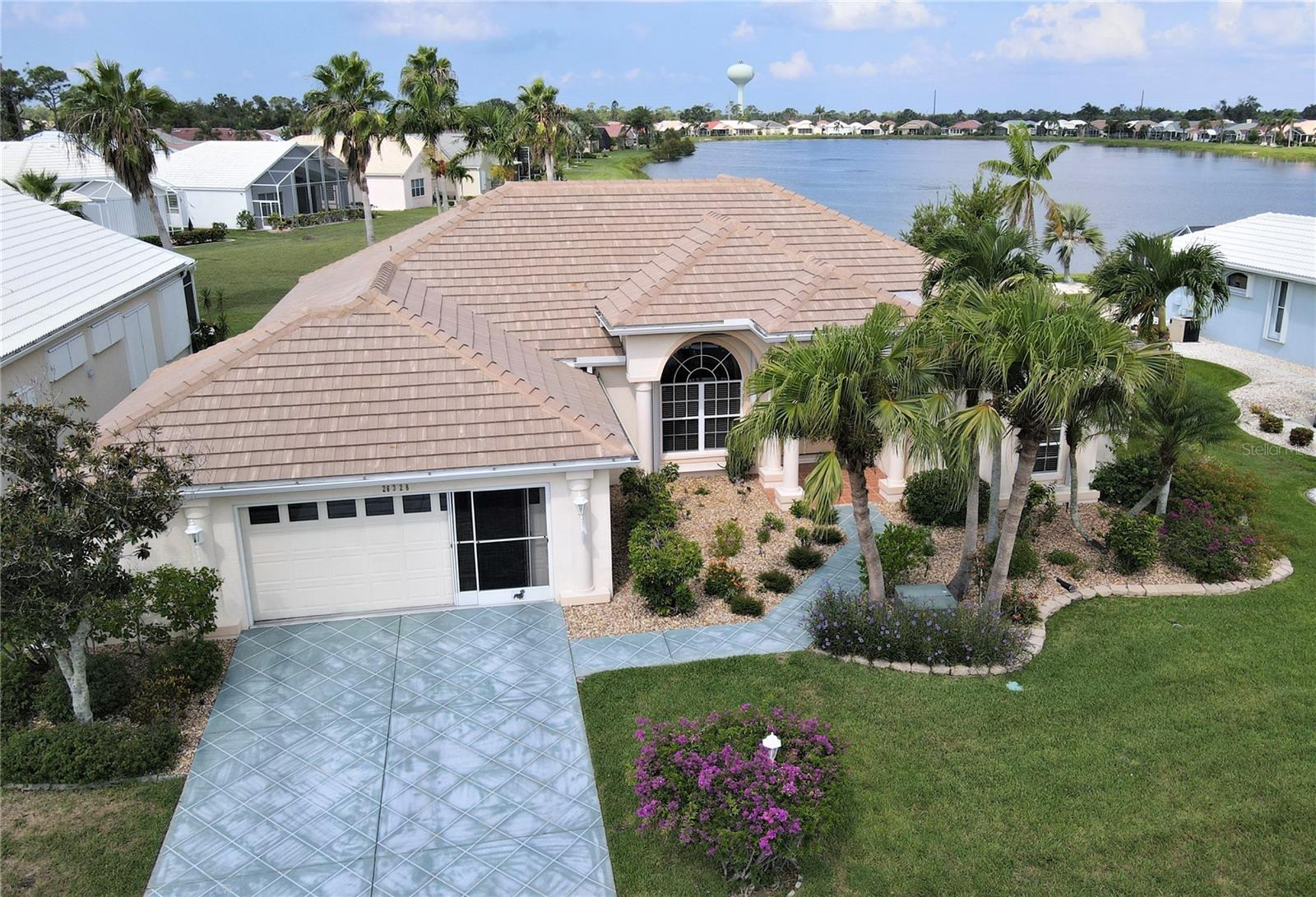 **PLEASE ENJOY THE 3D INTERACTIVE VIRTUAL TOUR ASSOCIATED WITH THIS LISTING – 

**PRICE IMPROVEMENT**Welcome home to the south Punta Gorda gated community of Seminole Lakes! Extremely well-built in 2000 for these original owners, this home has been meticulously cared for and tastefully updated and sports an inviting neutral decor! The base features of this one-of-kind home include an ultra-functional great room design with just over 2140 square feet of air-conditioned living space, including three bedrooms, two full baths, volume ceilings, an oversized two-car attached garage, an indoor utility room, and a massive screened and partially roofed rear-facing lakefront lanai, with direct access from the primary bedroom suite, great room and kitchen. This fantastic outdoor lakefront oasis, which measures approximately 960 square feet and includes a nearly 200' covered area, is where you'll find the 25'x13' heated pool with an attractive Pebble-tech surface and a complimenting paver-stone pool deck, all overlooking the communities' largest lake. 

The re-imagined eat-in kitchen enjoys beautiful hardwood cabinetry, stainless appliances, and spacious granite counters, including a breakfast bar and a dinette area with a lovely pool and lake view. The oversized primary en-suite bedroom, which also overlooks the screened pool enclosure and lake, has a spacious bath with a walk-in shower, garden tub, dual sinks, a water closet and twin walk-in closets. Other key features of this fine home include a new tile roof (2023), 12" ceramic tile flooring throughout and beautifully maintained tropical landscaping with a yard irrigation system. There is also a stamped concrete drive and walkway, complete window storm protection, a screened garage door and underground public utilities. 

26328 Seminole Lakes Boulevard is situated on one-and-a-half lots and enjoys a lovely long lake view and is just around the corner from the community pool and tennis courts. With just shy of 500 single-family homes, Seminole Lakes is a fully developed golf and tennis community located just five miles south of historic downtown Punta Gorda on Charlotte Harbor. Considered "maintenance-free," the low monthly fees include lawn care, 24-hour guarded access control, a community pool and tennis courts. The monthly fee also includes community road and lake maintenance. Individual homeowners are responsible for their home and shrubbery care and the tennis and golf access fees if of interest. The community features include eight freshwater lakes, the largest of which is nearly 25 acres, and access to the Seminole Lakes Golf Club, a semi-private 18-hole executive course. From this home, you are .3 miles from the community pool complex, 1.5 miles from shopping and only 2.5 miles from Interstate 75. Move-in ready; the only thing missing is you!