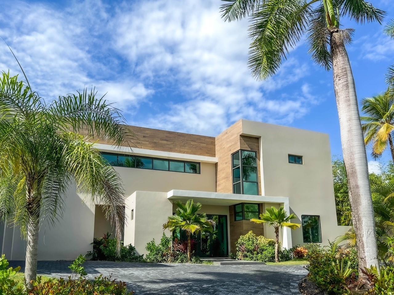 Brand new luxurious contemporary home with 7,700 sqf of air-conditioned living space for the discerning buyer. This architectural masterpiece, designed by renowned architect Jose Garcia, is surrounded by high-end multi-million dollar homes based in the sought after community of Dorado Country Estates, with direct golf cart access to the exclusive Dorado Ritz Carlton Resort. Inside living includes a great room and massive kitchen/waterfall island which anchors the home.  These rooms are complemented by a walk-in pantry, a family room and formal dining room, plus a ground floor guest suite. Luxury, high-end finishes include Subzero and Wolf appliances, European tile, custom Italian cabinetry, Kohler wall hung toilets and fixtures, and is equipped with Trane central air conditioning, a 60kw diesel generator and 1,200 gallon cistern. The Master Suite is a stunning retreat with views of the golf course and mountains, an over-sized walk-in Italian closet, walk-in shower, gorgeous tub, and Scavolini vanities.  All bedrooms are en-suite with tiled walls and walk-in showers. This beautiful estate consists of 9,500+ sqf construction space and sits harmoniously on a 2,000 sq meter lot (0.5 acre). The outdoor living area includes a covered patio and bathroom, and garage and driveway.
