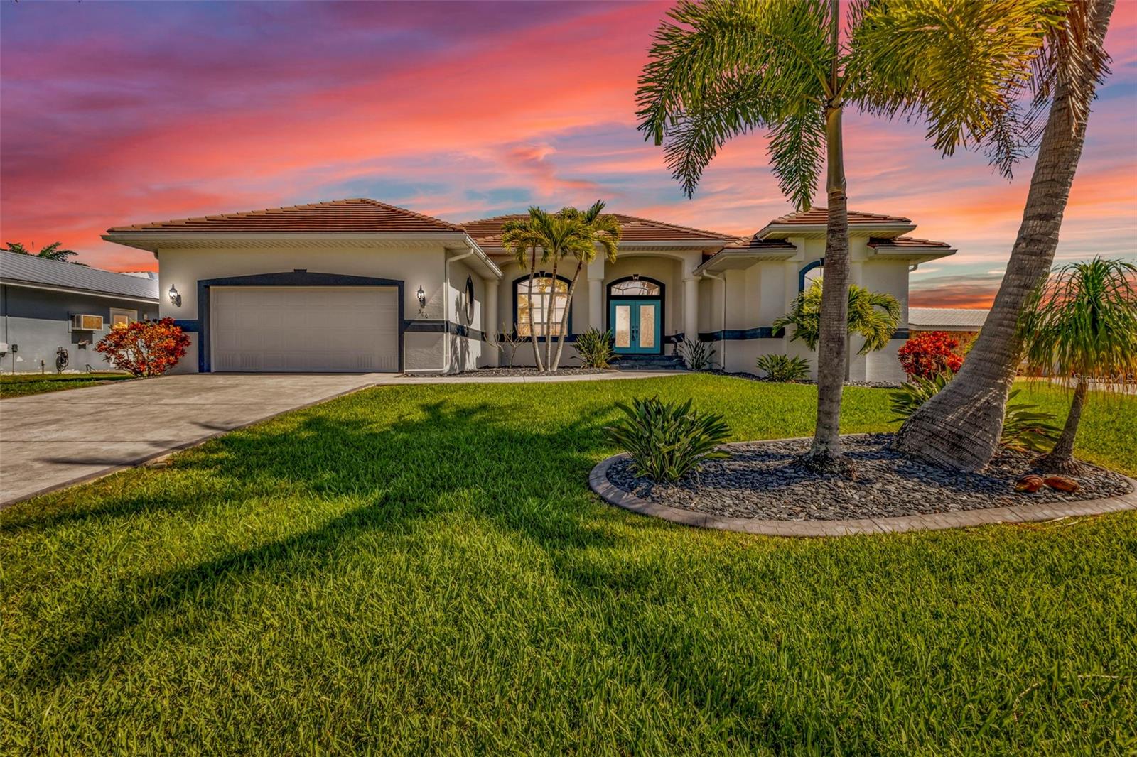 COMPLETELY REMODELED WATERFRONT HOME WITH FAST GULF ACCESS—MINUTES TO OPEN WATER! Experience elevated coastal living in this stunning 3-bedroom, 2-bath, 2,528 sq ft contemporary home ideally positioned on a scenic canal with direct access to Charlotte Harbor, Boca Grande, and the Gulf of Mexico. A true boater’s dream, the property features a private dock with a 10,000 lb lift with remote control, making time on the water effortless. The outdoor living space is equally impressive, offering a newly resurfaced saltwater pool and spa, custom-tiled outdoor shower, lush tropical landscaping, and a tranquil lanai where you can enjoy serene canal views alongside a custom-painted dolphin water feature. Inside, the open-concept design seamlessly blends elegance and comfort with lighted cathedral tray ceilings, crown molding, an interior/exterior sound system, and three sets of pocketing glass sliders that fully open to the lanai, enhanced by a remote-controlled electric screen for true indoor-outdoor living. The gourmet kitchen is a showpiece, featuring luxurious quartzite countertops, high-end stainless steel appliances, a beverage cooler, custom soft-close cabinetry, designer lighting, and a large center island perfect for entertaining. Just off the kitchen, a spacious bonus room offers incredible flexibility and is currently designed as a game lounge with a convertible pool/dining table, ideal for hosting gatherings or special occasions. The primary suite is a private sanctuary with a spa-inspired bath that includes dual vanities, a freestanding soaking tub, an oversized walk-in shower with herringbone tile detail and frameless glass enclosure, and extra-large his and hers closets. Additional highlights include a new tile roof (2024), new AC (2025), new Salt Cell for pool 2026, pool refinished in 2023, Manabloc plumbing system throughout, fresh interior and exterior paint, custom window treatments, new NuCore luxury vinyl plank flooring in the main living areas and primary suite, an oversized 2-car garage with epoxy flooring and a workshop area, all-new sod, curbing, professional landscaping, and a custom-designed painted mailbox. Ideally located just minutes from historic downtown Punta Gorda, Fishermen’s Village, PicklePlex, waterfront parks, golf, and award-winning dining, this exceptional residence offers the very best of Southwest Florida waterfront living, with an option to be purchased turn-key furnished minus a few exclusions.
