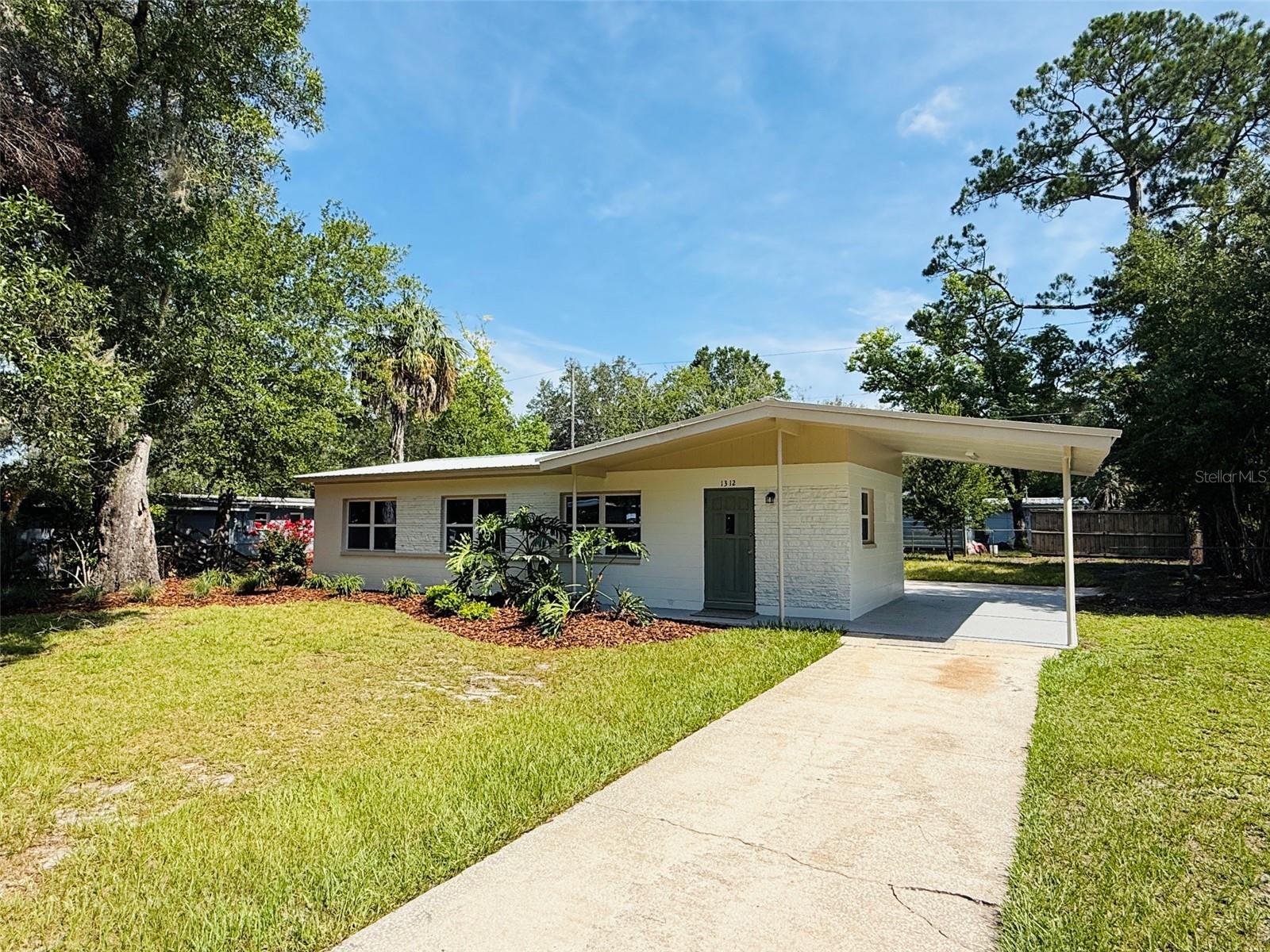 Welcome home to this beautifully remodeled 3-bedroom, 1-bath gem nestled in Highland Court Manor! Ideally located just minutes from Satchel's Pizza, Smokey Bear Park, Public & General, and with convenient access to the Gainesville Regional Airport, UF, and more, this home offers the perfect blend of charm, style, and location. Inside, you'll find a completely renovated interior featuring a stunning kitchen with granite countertops, beautiful white cabinetry, and modern finishes throughout. A brand-new metal roof provides peace of mind for years to come, while the single-car carport adds everyday convenience. Step outside to the spacious backyard where a cozy fire pit creates the perfect setting for entertaining friends, roasting marshmallows, or relaxing under the stars. Whether you're a first-time homebuyer, downsizing, or looking for a move-in-ready home in a vibrant community, this one checks all the boxes!