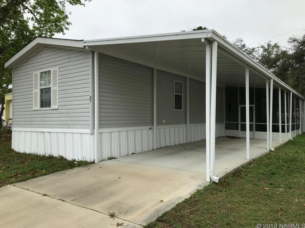 NO LOT RENT with this Fantastic three Bedroom, 2 Bath manufactured home, 1152 Sq Ft under air, Carport / Driveway to accommodate 3 cars or your toys, Shed, 3 year old Screened Covered Porch, LARGE KITCHEN with center Island & breakfast Bar, All Kitchen Appliances Included ( Frig 4 years new ) plus Washer and Dryer, New Flooring in Office / Bedroom, Master Bath is 7 x 15 ft. with double sinks and Garden Tub, INSIDE LAUNDRY, Move in Condition and quite Area which is close to Shopping, the Beaches and the Speedway ! ;Water: City