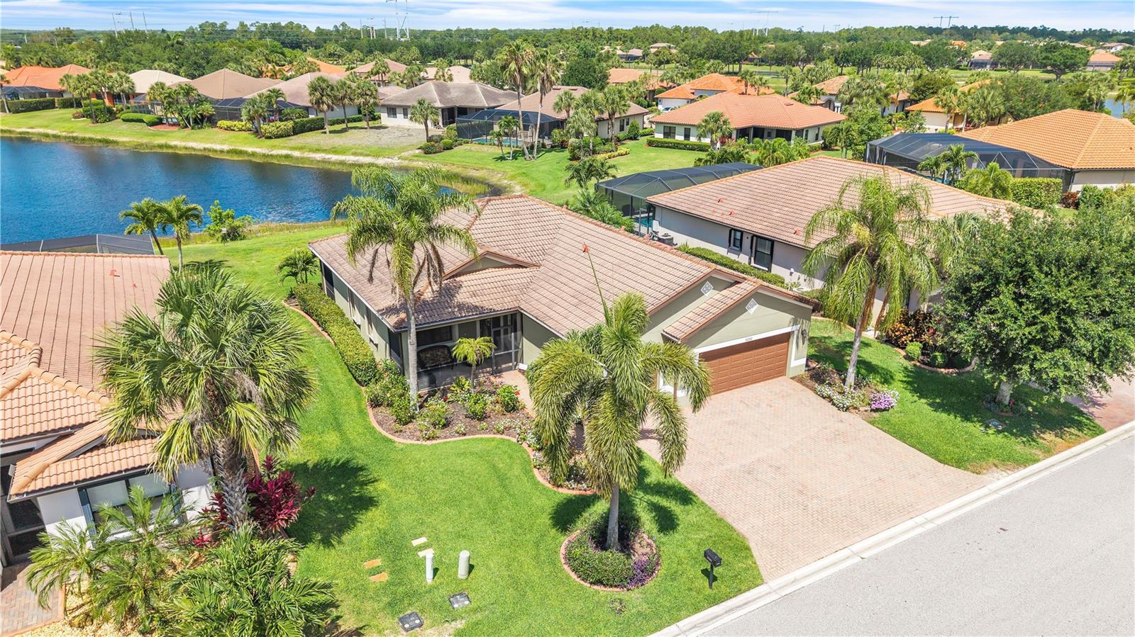 Welcome to Hampton Park at Gateway, where comfort, space, and serene lakefront living come together in this beautifully maintained 3-bedroom, 2-bath home with a 3-car garage. Perfectly situated on a waterfront lot with mature landscaping, this spacious open-concept residence offers the ideal blend of elegance and everyday Florida living.

Inside, you’ll find crown molding, tile flooring throughout the main living areas, and an abundance of natural light that enhances the home’s airy, inviting feel. The well-appointed kitchen features granite countertops, stainless steel appliances, ample cabinetry, a dedicated pantry, breakfast bar seating, and a cozy dinette area overlooking the living space and peaceful water views beyond. 

The spacious primary suite serves as a relaxing retreat with tranquil lake views, a huge oversized walk-in closet, and an ensuite bath complete with dual vanities, a soaking tub, and a walk-in shower. Two additional bedrooms, positioned next to the additional full bathroom, provide flexibility for guests, a home office, or hobbies.

Enjoy true indoor-outdoor Florida living from the screened rear lanai overlooking the lake and expansive backyard space, while the screened front entry porch offers yet another inviting spot to relax and enjoy the breeze.

Located within the highly desirable gated community of Hampton Park at Gateway, residents enjoy resort-style amenities including a clubhouse, fitness center, community pool, playground, and sports courts, all conveniently located just a short walk from the home. Imagine evening strolls to the pool instead of hunting for parking keys and flip-flops in a rush.

Conveniently located near shopping, dining, I-75, RSW International Airport, and Southwest Florida’s beautiful beaches, this home offers the perfect combination of peaceful living and everyday convenience.  Schedule your showing today.