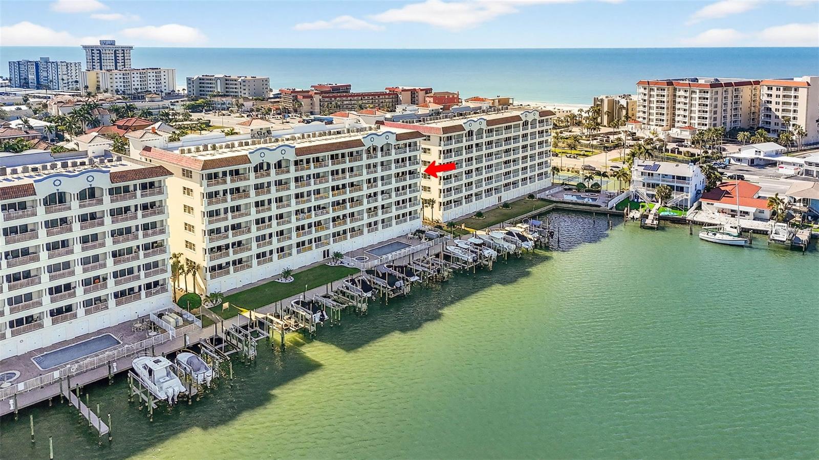 Stunning Waterfront Corner Condo with Panoramic Gulf, Bay & Intracoastal Views in a Gated Community with 24x7 Security. Experience the ultimate in luxury coastal living with this beautifully maintained 4th floor, 3-bedroom, 3-bathroom corner condo in the prestigious Redington Shores Yacht & Tennis Club, Las Flores building. This expansive 2,000 sq. ft. end unit offers some of the very best panoramic views of the Gulf, Boca Ciega Bay, and the Intracoastal Waterway. Turnkey ready, the residence features impact-rated windows and sliders, soaring 10’ ceilings, newer flooring, designer lighting fixtures, and custom window treatments. The chef’s kitchen is a showstopper, boasting natural stone countertops, a new backsplash, custom solid wood cabinetry, a center island, and seating for four at the breakfast bar. A custom wine and beverage center adds a stylish touch for entertaining. The spacious dining and living area are warm and inviting, highlighted by the GULF and Intracoastal water views. The generous primary suite is a private retreat offering stunning water views, a large-screen TV, a spacious primary bath with a lavish walk-in shower and soaking tub, and direct access to the private 200 sq. ft. balcony, which is also accessible from the living area and perfectly positioned for enjoying sunsets. Bedrooms two and three each feature en-suite baths, large walk-in closets, and high-end plantation shutters. Recent upgrades include a newer HVAC system (2019) with a full warranty still in effect, a new water heater (2025), a freshly painted exterior (2023), a brand-new roof (2024), and a complete, elegant refurbishment of the building and community landscaping. Additionally, a unique feature valued at over $40,000 is the 10’ x 10’ cabana, which includes electricity and can store beach toys, kayaks, or house a refrigerator/bar. This cabana can be purchased with the unit. Moreover, within this exclusive guard-gated community, you'll enjoy resort-style amenities such as lighted tennis and pickleball courts, a newly remodeled clubhouse with all new state-of-the-art fitness equipment (2026), and a newly resurfaced heated pool with spa (2025). The community offers a scenic waterfront boardwalk with a dedicated kayak and paddleboard launch. There is a private back gate that provides easy access to the beach via a flashing crosswalk and paved walkway for your beach carts. Las Flores also has its own private newly resurfaced (2025) heated pool and spa overlooking Boca Ciega Bay. Two small pets are welcome and 30-day minimum rentals are permitted. This exceptional condo can be sold fully furnished for a turnkey experience or unfurnished to suit your needs. Walk to amazing restaurants, bars, shops, spas, and salons. This is truly an extraordinary opportunity to own one of the finest residences on the Gulf Coast.