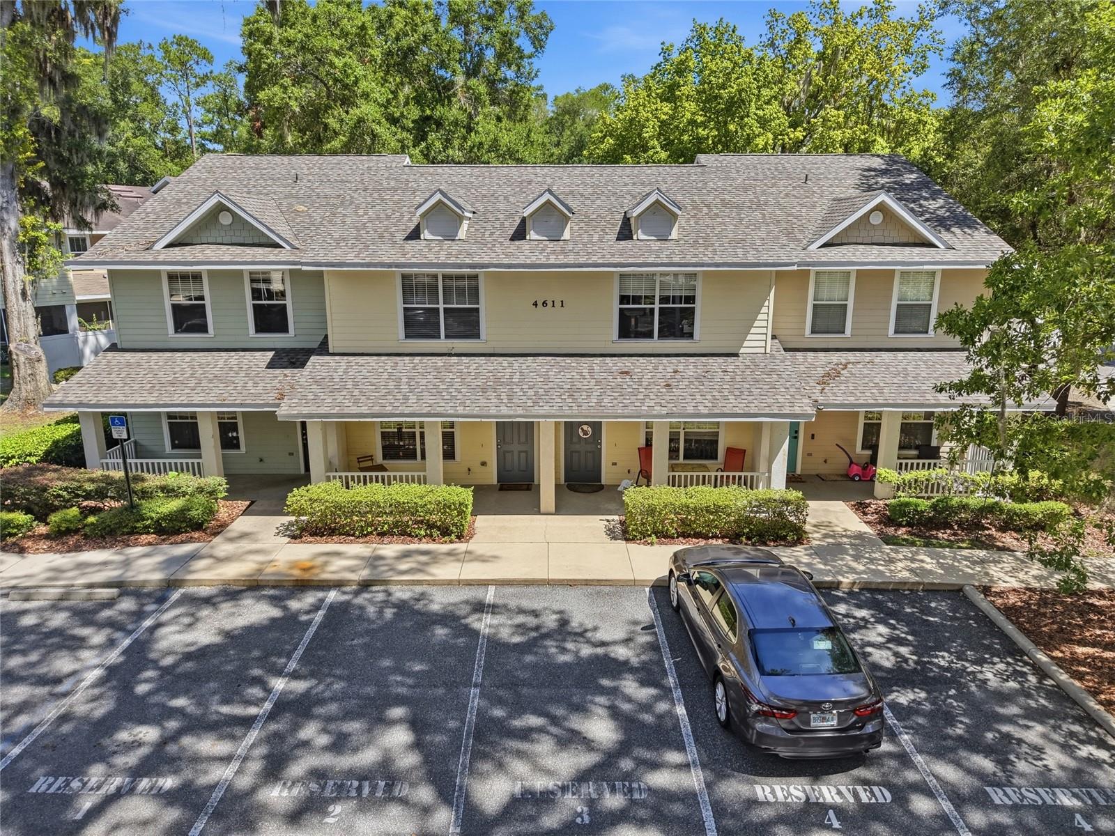 Welcome to Hailey Forest, where low-maintenance living meets one of Gainesville's most convenient locations. Framed by a magnificent granddaddy oak at the front of the home and surrounded by the community's mature live oak canopy, this well-maintained 2-bedroom, 2.5-bath townhome offers an ideal blend of comfort, functionality, and privacy. Perfect for a primary residence, a UF student, a medical professional, traveling nurse, or anyone looking for a move-in-ready home close to everything.

Inside, you'll find an inviting open-concept living and dining area with updated luxury vinyl plank flooring, a spacious kitchen, and abundant natural light. The living space opens to a private screened porch overlooking peaceful green space, creating the perfect spot to enjoy your morning coffee or unwind after a long day.

Upstairs, both generously sized bedrooms feature their own private en-suite bathrooms, providing an ideal setup for roommates, guests, or a dedicated home office. Two assigned parking spaces, along with convenient guest parking just outside the unit, make everyday living even easier.

Enjoy the benefits of condominium living with an HOA that covers building insurance, roof replacement, exterior maintenance, lawn care, pest control, termite bond, trash service, and more, giving you more time to enjoy your home instead of maintaining it. Residents also enjoy a community dog park. 

Located just minutes from the University of Florida, UF Health, the VA Medical Center, the new HCA hospital, Celebration Pointe, Butler Plaza, I-75, and Gainesville's best shopping and dining, this home offers the convenience buyers are looking for in a community they love.