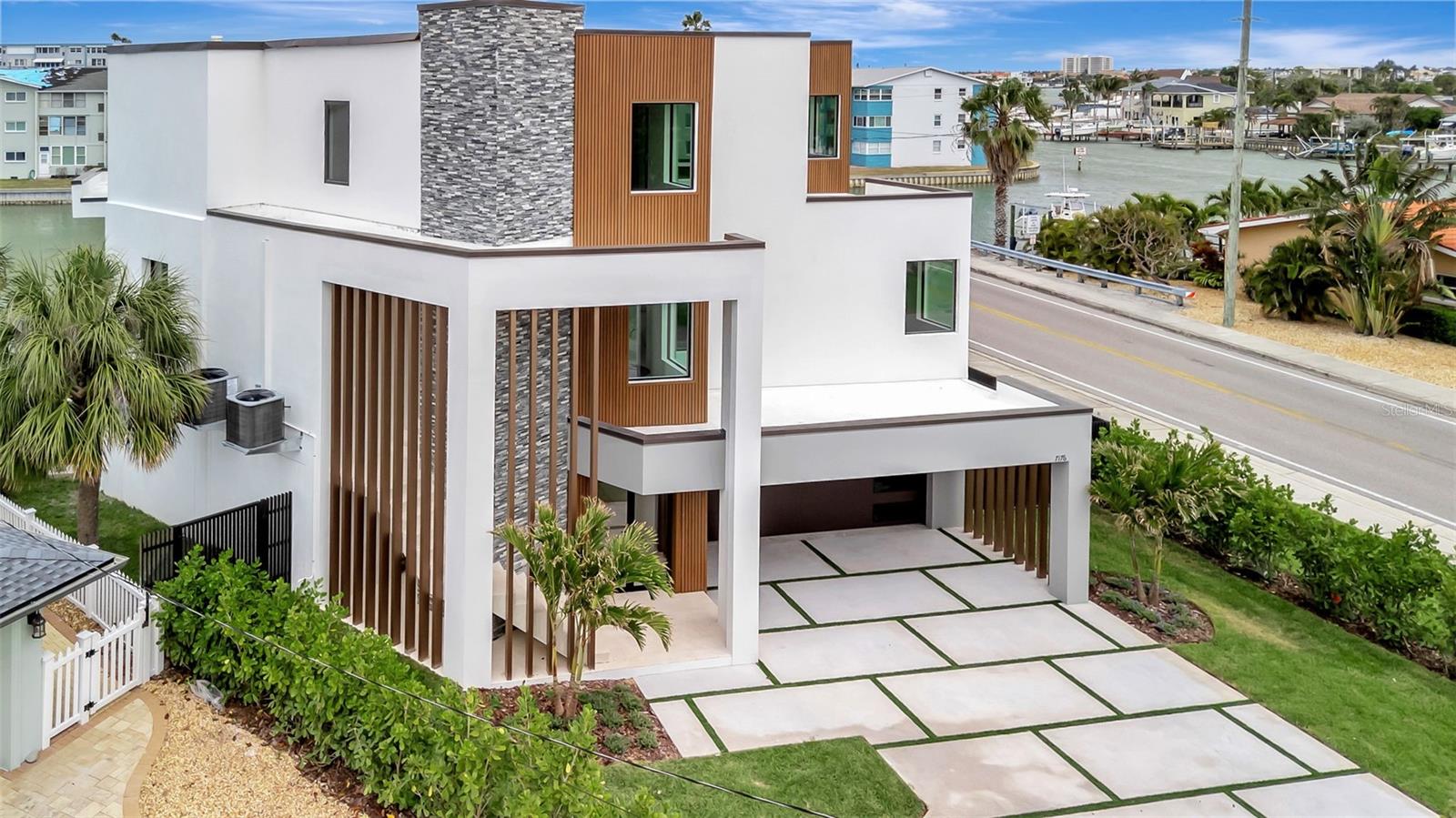 Newly Completed. Modern Waterfront Luxury Estate in Pasadena Isles. Discover this extraordinary modern European-style masterpiece by Everstone Development. This stunning elevated two-story waterfront estate features 5 bedrooms, 4 full bathrooms + 2 half bathrooms, and over 4,000 sf of living space. Boasting direct frontage on the Intracoastal Waterway (Boca Ciega Bay), the home offers breathtaking water views and effortless coastal living, just a 5-minute drive from the beach. Wake to the gentle sounds of the water, enjoy effortless days of boating and water sports, and end each evening with spectacular golden sunsets from your own backyard oasis. The expansive open-concept design seamlessly blends indoor and outdoor living with 80 feet of dramatic floor-to-ceiling glass that frames sweeping views of the sparkling pool and serene waterway beyond. Step outside to the expansive 40-foot covered lanai, perfect for year-round alfresco dining and entertaining while soaking in the sunset views. The property includes a large private dock, ready for your boat lift to be installed, ideal for a quick access to some of the area’s best fishing spots. Additional highlights include: A state-of-the-art elevator for effortless access to all levels, a 4-tandem car garage with ample room for vehicles, water toys, beach gear, or a hobby workshop and a private media room. The expansive outdoor living area is a true showstopper, featuring an oversized patio with abundant open space perfect for launching kayaks or paddleboards, hosting lively gatherings, or simply unwinding in style. At the heart of the space sits an outdoor kitchen complete with a built-in grill, offering the ultimate convenience for a dining and entertaining.  Whether you're hosting sunset cocktail parties, family barbecues, or relaxed waterfront dinners, this generous area seamlessly blends luxury and functionality. Every vantage point delivers stunning waterfront views across the sparkling pool to the serene Intracoastal Waterway beyond, creating an inviting backdrop that makes every moment feel like a private resort escape.
Thoughtful design that prioritizes both luxury and functionality for today’s modern lifestyle.
Located just 20 minutes from vibrant downtown St. Petersburg, you’ll enjoy easy access to world-class dining, shopping, cultural attractions, and the iconic St. Pete Pier. This is more than a home — it’s a private waterfront sanctuary where every day feels like a vacation.