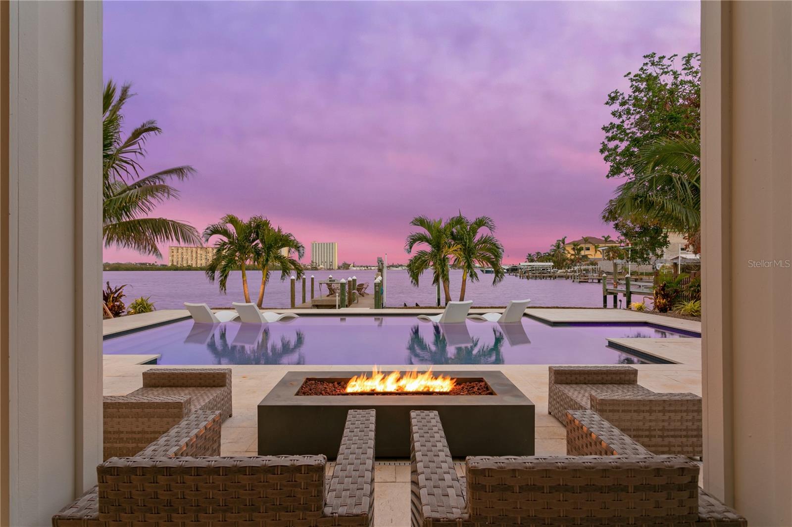 Coastal living at its finest. This elevated waterfront home was built in 2021. Built to entertain this home has 3300sq ft of heated living and over 2200 of covered outdoor porches with exotic wood ceilings to take advantage of both the sunrise and the sunsets. It includes gas lights, TWO outdoor kitchens, TWO outdoor fireplaces, surround sound, bonus spaces, oversized saltwater pool with hot tub, up lighting, tropical landscaping, composite decking on dock with fish cleaning station, 13,000lb boat lift, floating dock and that’s just the outside. 
When you step inside you are immediately captivated by the views. This 5 bedroom home has high ceilings, water views from every room in the house and was custom built in 2021. All centered around a dream kitchen. The kitchen boasts custom cabintry, walk in pantry, all state of the art high end appliances to include a natural gas 48in stove, wine cooler, built in coffee machine, ice maker, beverage drawers, luxury hardware and leathered quartzite counter tops. With engineered hardwood flooring, custom bathroom and closet cabintry, custom blinds, solid hardwood doors, fiive security cameras surround the home, Sonos surround sound speakers, a double sided fireplace, entire home and faucet water filtration system and wifi connectors inside out only names a few of the many features this home has. There is nothing more to do but move in and enjoy the breathtaking sunrise and sunset views this home has. A home that offers peace and tranquility when you need it and a boater/entertainers dream when you want it.
Minutes to the beaches and downtown St. Petersburg make this an ideal location and most importantly its located in the highly desirable and highly coveted Yacht Club Estates. CHECK OUT THE VIRTUAL TOUR