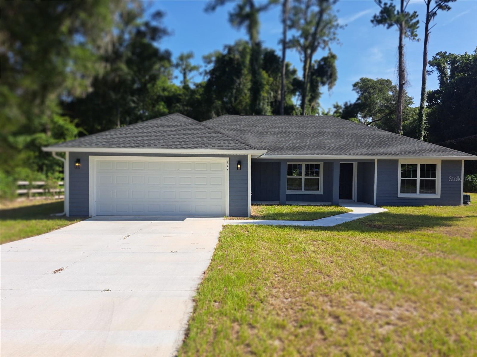 The owner had to move due to employment change, take advantage of this almost brand new 2025, 3 bedroom 2 bathroom 2 car garage home with over 1,700 square feet of living space. The property is over ¼ acre and is located on a corner lot just 1 block from the Withlacoochee River. The subdivision is tucked away in a one way in and one way out neighborhood for added privacy. Features include rain gutters around the entire exterior, a big front porch, cathedral ceilings, luxury vinyl plank flooring throughout, a huge great room with an upgraded ceiling fan as well as in all of the bedrooms, a gourmet eat in kitchen with beautiful cabinetry, quarts counter tops, a pantry, a custom stainless steel vented range hood, stainless steel appliances and a big island, the master suite has a large walk in closet, a double sink vanity, and a ceramic tiled shower. Leading to the rear of the home is a set of glass paneled French doors which takes you to a covered porch and a big back yard. Other features include a new washer and dryer, a water softener, a whole home dehumidifier, and an energy recovery system for fresh air in stale air out. This is one stunning home, make your appointment to see it today.