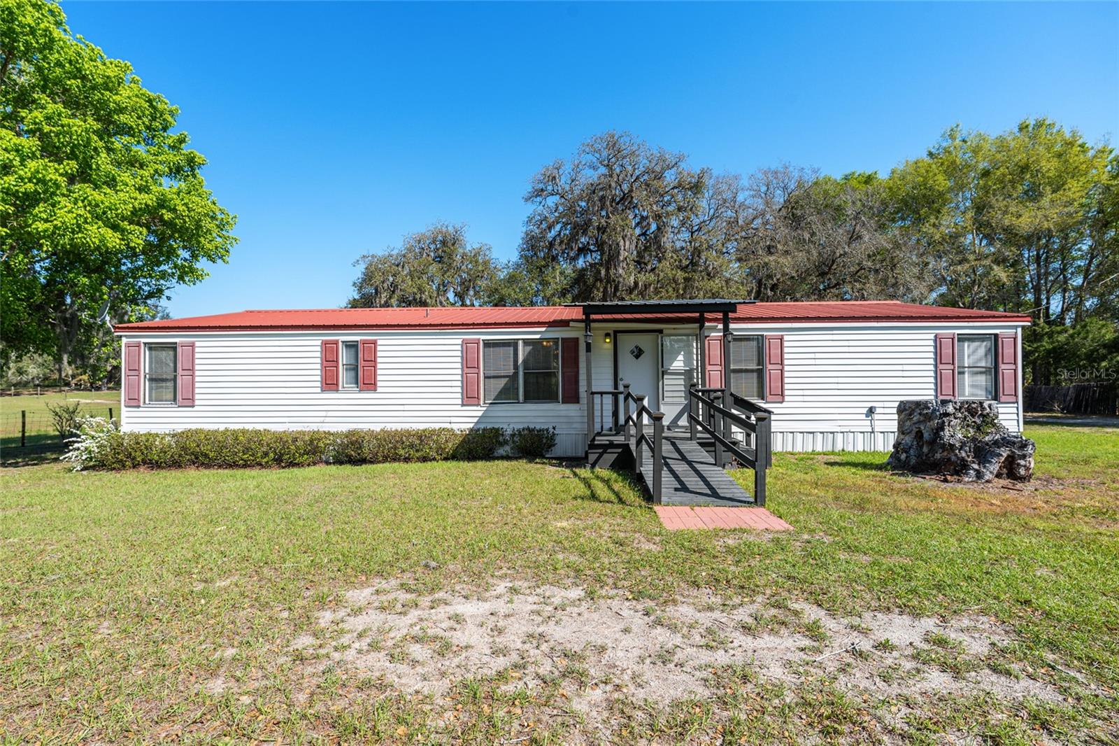 AMAZING 5 ACRE PROPERTY! BRING YOUR OFFERS, SELLER IS MOTIVATED. If you’re looking for space, privacy, and the perfect setup for homesteading, this is it. This 3 bed / 3 bath home sits on a fully fenced and cross-fenced lot with a gentle roll great for livestock and just beautiful to look at.

The property is already set up with everything you need: a fenced garden area with sprinkler system, chicken coop, concrete dog kennel,  a workshop, and an extra storage building.

The home offers a comfortable open layout with a split floor plan, and each bedroom has its own full bathroom which is super convenient. The kitchen features a breakfast bar and a deep double sink, and there’s plenty of space with a separate dining area and a large living room for family time or entertaining.

You’ll also love the covered back porch perfect to relax and enjoy the view. No HOA, and still an easy drive to Gainesville or Trenton. Move-in ready and a great opportunity you don’t want to miss!