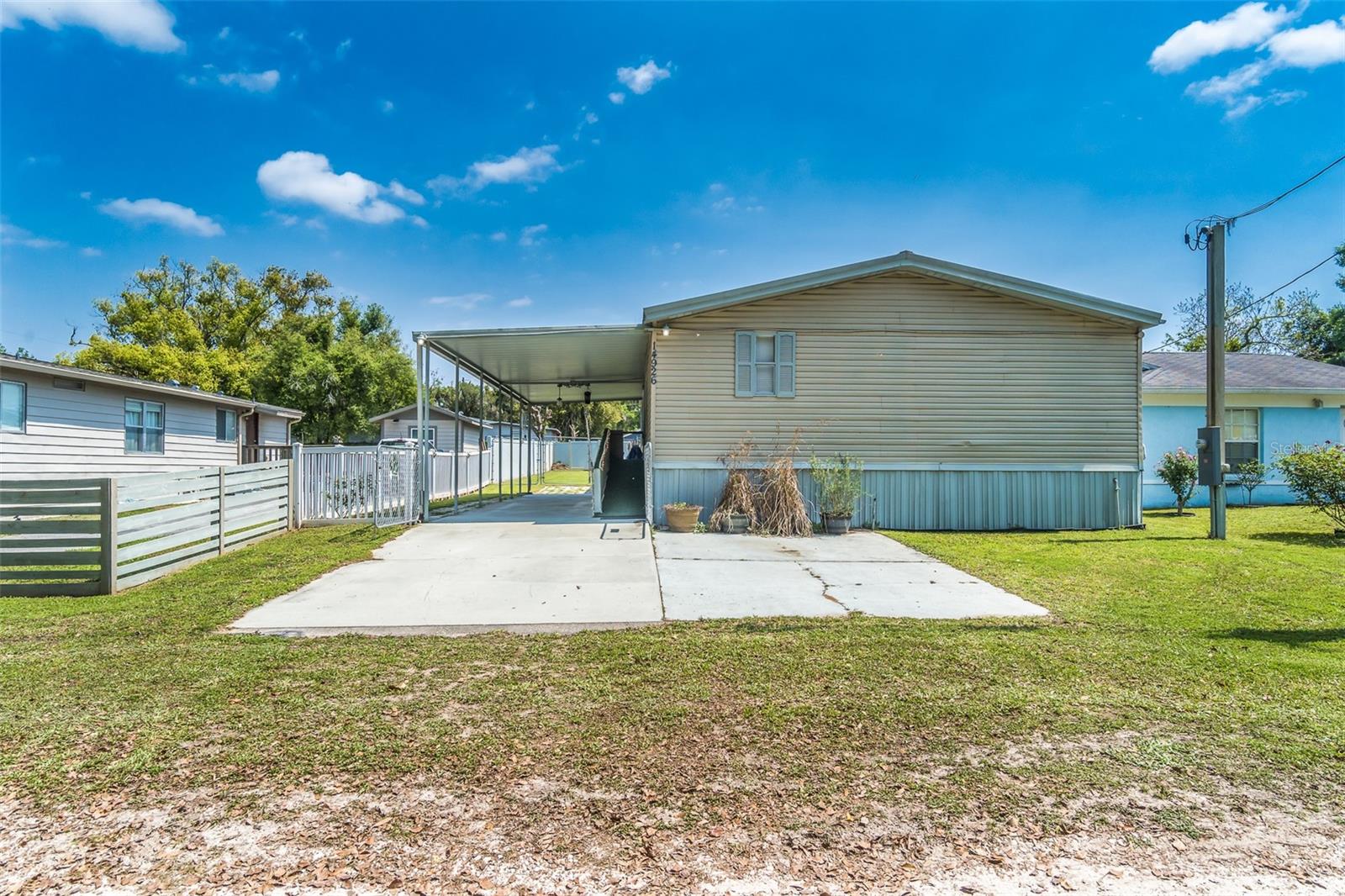This well-maintained mobile home features 3 bedrooms, 2 bathrooms, and a 2-car carport, and is located in the heart of Dade City. Dade City is known for its rich culture, old Florida charm, hometown events, stunning rolling hills, festivals, and a blend of city and country life, as well as nearby state parks and more!

Situated on a peaceful dead-end country road, this home offers tranquility with minimal traffic, making it ideal for family living. The spacious, private fenced-in yard is perfect for adding a pool, accommodating garden enthusiasts, and providing space for ATVs, pets, family fun, and more.  NO HOA'S OR CDD'S!

The large open entertaining area includes a living room and formal dining room, making it perfect for hosting guests, celebrating holidays, or enjoying family time. The kitchen is pre-plumbed for a dishwasher and features a morning room, along with a flexible space that can be used as an office, homework station, hobby area, and more.

The primary bedroom includes an en-suite bathroom, while the two additional bedrooms share a secondary guest bathroom. There's a separate laundry room that comes with updated washer and dryer. The rear door features a cat/dog door leading to the fully fenced-in backyard. The A/C unit is approximately 6 years old, and the METAL roof is about 8 years old. 

Call today for your private showing!