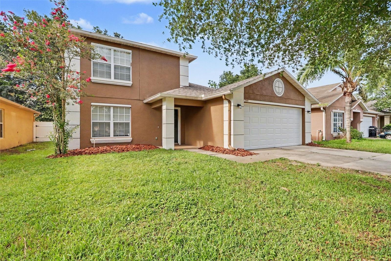 Five-bedroom, 2.5-bathroom, two-story home features a functional and carpet-free interior with tile and laminate flooring throughout. The main level is designed for both formal and casual living, offering a welcoming formal living room at the front and an eat-in kitchen equipped with stainless steel appliances. Complete with an attached two-car garage, this home offers a low-maintenance and spacious layout ideal for modern living. Schedule your showings today!