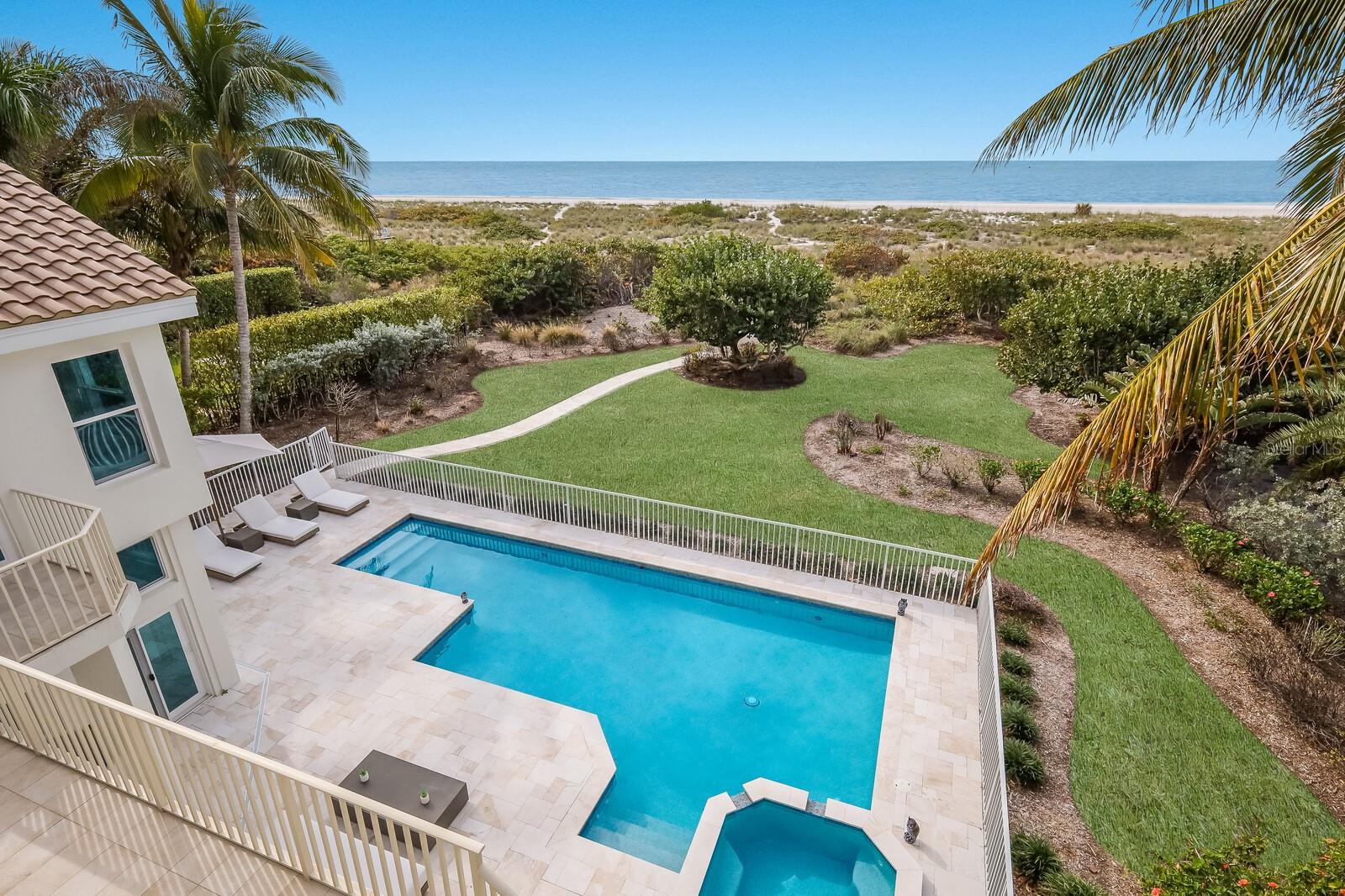 Experience the pinnacle of coastal luxury at this magnificent 4 bedroom beachfront residence on Longboat Key. Nestled along the pristine shores of the Gulf of Mexico,  this remarkable home offers the perfect blend of contemporary style, relaxation, and elegance. With breathtaking views of the Gulf, every evening becomes a masterpiece as you watch the sun slowly dip below the horizon from the comfort of your private oasis. Immerse yourself in the heated beachfront pool or soak in the hot tub, letting the soothing sounds of the waves envelop you. This residence boasts a spacious 4-car garage, providing ample space for your vehicles and watercraft, ensuring you're always ready for a day of adventure on the water. Inside, the open and airy living spaces are thoughtfully designed with an emphasis on maximizing views and creating a warm, inviting atmosphere. The gourmet kitchen, adorned with top-of-the-line appliances and a spacious island, invites culinary creativity, whether you're whipping up a romantic dinner for two or hosting a grand celebration. With five beautifully appointed bedrooms, there's ample room for family and friends to share in this coastal paradise. The master suite is a sanctuary of comfort and style, featuring its own private balcony for you to savor the colors of the sunset and the gentle ocean breeze. The ensuite bathroom offers a spa-like experience, complete with a luxurious soaking tub. But the real magic lies just beyond your doorstep. Step onto the sugar-white sands of Longboat Key, where you can take long walks along the beach, collecting seashells and creating memories. The beach is your backyard, inviting you to swim, sunbathe, or simply enjoy the tranquil sounds of the sea.  Longboat Key offers a unique blend of natural beauty and cultural delights, from exploring nearby parks and wildlife preserves to savoring world-class cuisine at local restaurants. Whether you're a nature enthusiast, an art lover, or a gourmet connoisseur, this location offers something for everyone.  This 5-bedroom beachfront haven on Longboat Key isn't just a home; it's an invitation to a life of luxury, where every day is filled with breathtaking sunsets, beachside strolls, and romantic moments. Discover the ultimate coastal lifestyle and create unforgettable memories in this exquisite retreat." Bedroom Closet Type: Walk-in Closet (Primary Bedroom).
