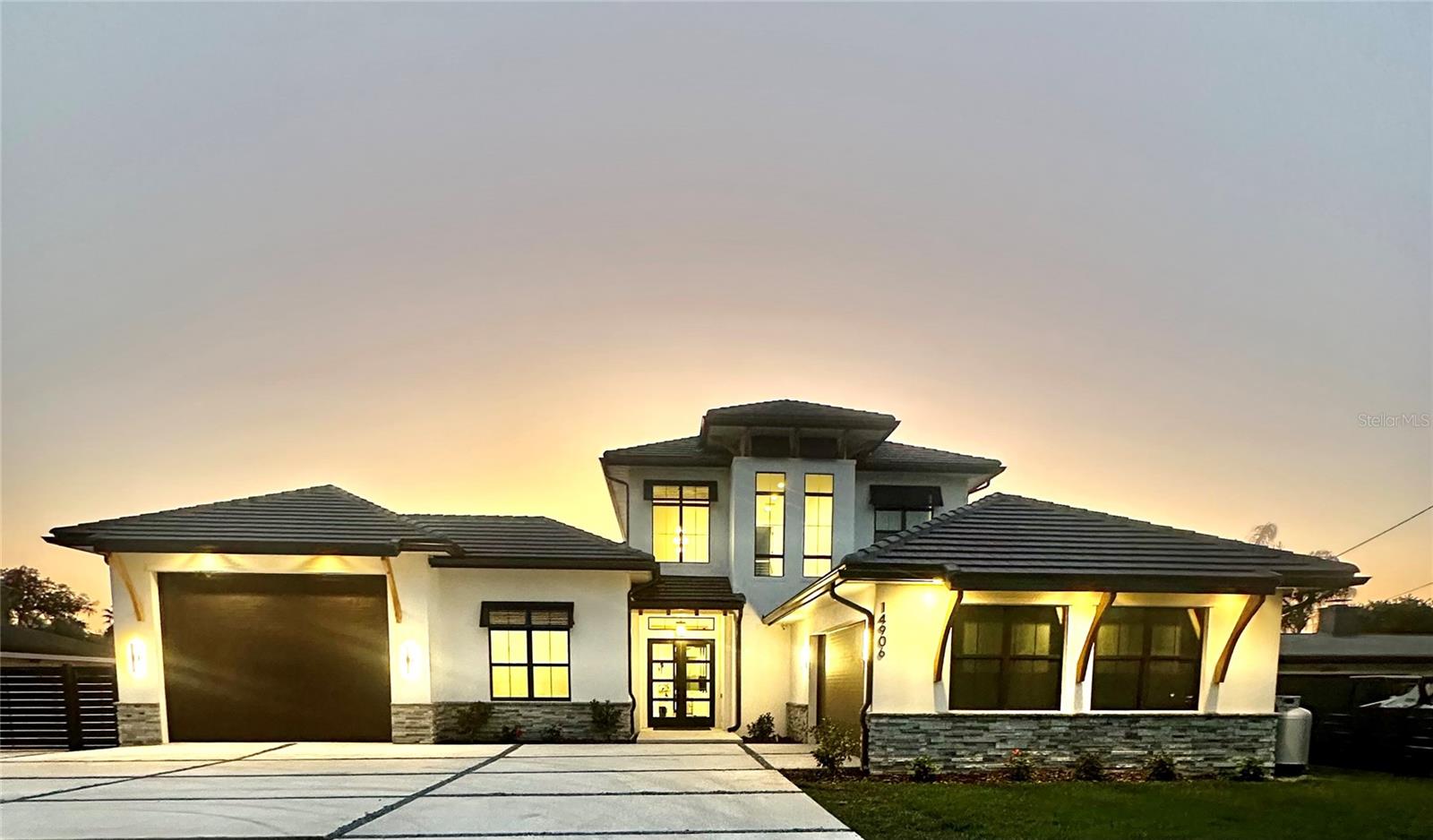 2024 Custom Coastal Sol II home by Arthur Rutenburg Lyon Heritage. This Green rated, modern gem on Lake Magdalene in the heart of Tampa has it all! Loaded with upgrades throughout, pool, spa, outdoor Kitchen, 2 story dock, private boat launch, boat slip, Ez-Dock for jet skis, and pull through boat garage. 4 bedrooms, 2 on first floor with en-suite baths. Wake up to serene lake views from the Primary bedroom with its gorgeous en-suite bath. Upgraded kitchen, within the beautiful great room with 10’ sliders to the lanai and pool. Den off of the kitchen. Second floor has 2 bedrooms, full bath, huge Bonus room with kitchenette, screened balcony for more incredible views, and a second floor laundry room for convenience. This home has it all! A great multi-generational home giving you the best of Florida! No HOA, just donations for fireworks for 4th of July right on the lake! Lake Magdalene is 252 acre ski lake with Largemouth Bass, Common Snook, and Red Drum. Boat slip is 10,000 lb. Furniture, some art, jet skis, kayaks, and paddle boards all negotiable. Located in Carrollwood, close to all highways, Airport, Busch Gardens, Downtown, Raymond James Stadium, Amalie, Armature Works, Hyde Park, University of Tampa, USF. Close to Carrollwood Day School, an all IB (International Baccalaureate) school, grades 1-12, with separate campus for PreK and Kindergarden close by. Also, Corbett Prep, IB, Grades Prek3-8th.