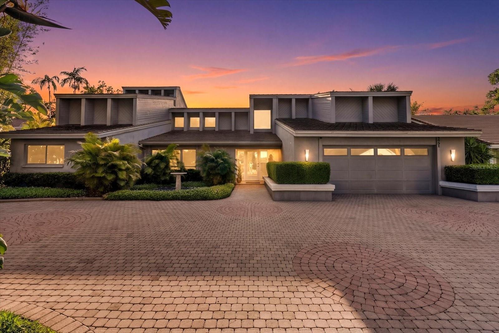 Tucked within the winding, tree-lined streets of one of Sarasota's most coveted west of trail communities, this architectural gem offers a rare opportunity to own a signature custom home in The Landings. With over 3,800 square feet of living space, four bedrooms, four full baths, and a powder room, this 1983 residence is the epitome of elevated design - where bold architectural character meets serene, sanctuary-style living.
Soaring vaulted ceilings and dramatic spiral stairwells set the tone from the moment you enter. An elevated library nook invites quiet retreat, while custom stained glass windows cast beautifully filtered light throughout the day. A dedicated meditation space adds a dimension of wellness rarely found in residential design - your own private escape to find balance and calm.  The outdoor living experience has been thoughtfully reimagined. A resurfaced private pool anchors the expansive lanai, now complemented by a generous outdoor kitchen ideal for entertaining or simply savoring the Florida lifestyle in style. Life at The Landings extends well beyond your front door. Winding roads shaded by mature canopy trees, neighborhood lakes, parks, and nature trails create an idyllic backdrop for morning walks, cycling, and quiet reflection. Residents enjoy direct access to Roberts Bay, and the community's optional Racquet Club offers swimming, tennis, and lessons just a short bike ride away — a lifestyle as active or as tranquil as you choose.
This is more than a home. It is a retreat, a statement, and a community.