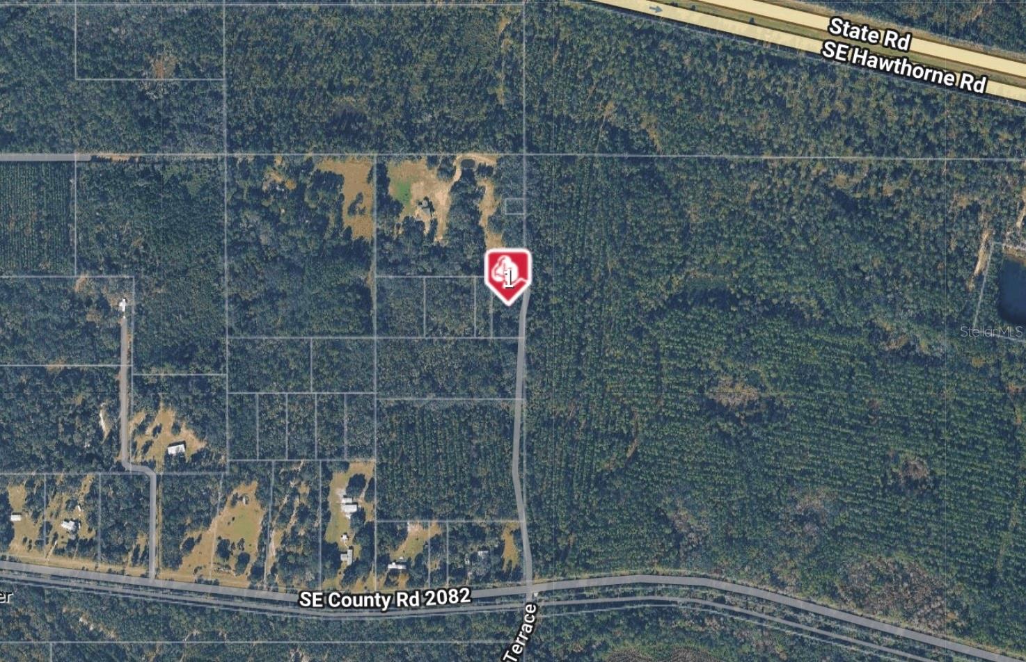 Don’t miss this rare chance to own two adjoining parcels being sold together, offering approximately 1.5 acres of peaceful, natural land just southeast of Gainesville.

One parcel (with a tax address of 10702 SE County Road 2082) is approximately 1 acre, and the neighboring parcel adds an additional 0.5 acre, creating a generously sized combined property.

Tucked away in a quiet, rural setting just south of State Road 20, this property offers privacy and a serene, wooded environment. The land remains in its natural state and backs up to a county preserve on the east side, providing added tranquility and a beautiful natural backdrop.
Please note: there is currently no direct road access or recorded easement to the property. Buyers are encouraged to conduct their own due diligence regarding access and future use. County guidelines indicate that additional acreage may be required to qualify for a building permit.
This is a great opportunity for those seeking future potential or a long-term investment in the Gainesville area.