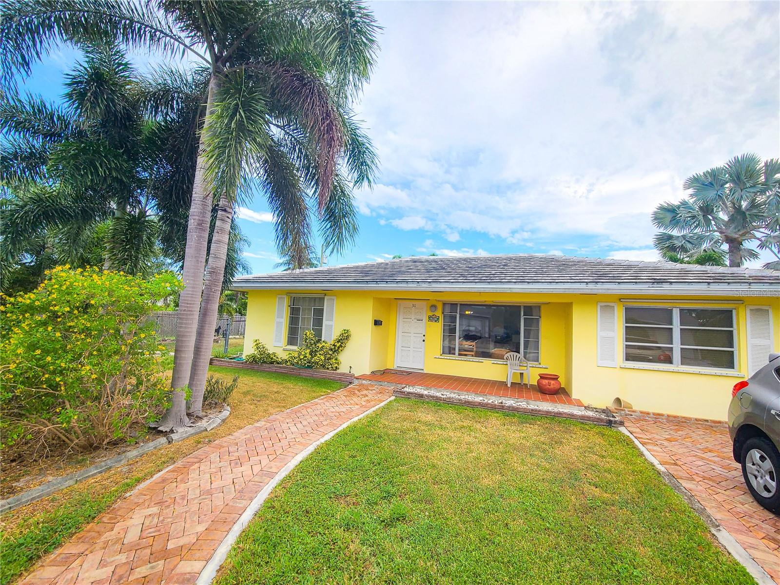 Located just minutes from the Atlantic Coast and Lake Worth Beach Park, this charming home is perfect for those looking to take advantage of Florida’s relaxing coastal lifestyle. Resting on a large corner lot, the property is accented by tall palm trees, brick paver walkway and driveway, and a covered front patio. A classic Florida style home, the interiors are light and bright with over 1,300 sq.ft. of space. Offering a total of 3-bedrooms and 2-bath, the home features lots of natural light and tile flooring throughout. The kitchen is well appointed with lots of cabinet storage, solid stone counters, and some stainless appliances and provides easy access to the formal dining area. Each bedroom is nice and roomy, with wood-look tile flooring for a sophisticated finish. The laundry area comes equipped with built-in shelving for added storage options, making it easy to stay organized.Towards the back of the home is a set of French doors that leads to the Florida Room, which provides plenty of light and directly overlooks the backyard. A sliding glass door opens up to the screen-enclosed patio, which includes an additional storage area and lots of space for shaded seating. A true gem of the home is the large, private backyard that features a sparkling in-ground pool and spa surrounded by a large brick-paver pool deck. Mature landscaping and tall palm trees accent the backyard, which is fully fenced and includes an additional storage shed with plenty of room for a lawn mower and other needs. This property is highly convenient to a large variety of shopping, dining, and outdoor opportunities, including several within walking distance. Lake Worth Beach Park is just 2.7 miles away, making this a wonderful option for those looking to spend time soaking up the sunshine. West Palm Beach is just 6 miles away, opening up even more options to enjoy nearby. Fort Lauderdale is roughly a 45 minute drive away while Miami is about an hour drive, providing a variety of opportunities to explore without much fuss! If you’re ready to enjoy Florida’s year-round sunshine and get the most out of the area’s beaches, this is a wonderful option to consider!