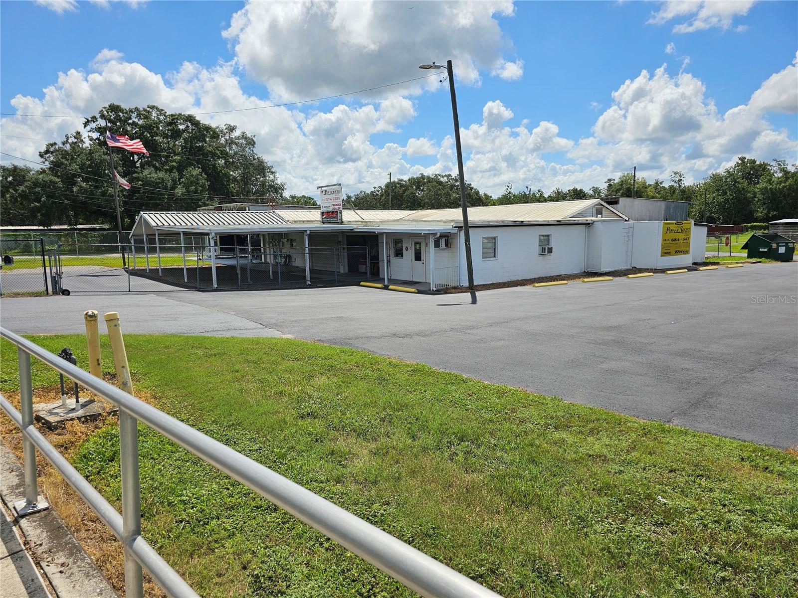 ATTRACTIVELY PRICED COMMERCIAL PROPERTY.!! What a Spectacular high visibility commercial business location. Next to a major lighted intersection on an extremely busy street in the heart of a business district. Enormous multi -use commercial space with reception, show room, offices, storage, parts warehouse, repair shop and so much more. There is secure fenced parking for special covered and open secure storage and parking needs. Alongside is an open extra large paved parking and storage with parking and storage for over 30 spaces. This is the retired location of a long-time boat sales, storage, service and repair facility for over 30 years. There is a sizeable air conditioned reception/sales counter and waiting area. An adjoining office is convenient for the support staff and has an ample files storage area. There are secure covered display areas for sales of boats, cars, RV, parts and many other uses, such as office complex, mini storage and more. There is a separate airconditioned executive office with a private and interior entrance. Need a machine shop? There are separate spaces customarily used for machine shops. There is a huge internal parts storage and warehouse area or can be easiy adapted to addition repair shops, machine shops or more. There are 4 enormous rear entry bays that are perfect for boat, automobile, motorcycle and RV servicing and repairs. There is a vehicle lift for servicing and repairs. Another bay has a sliding double hoist lift for movement of repairs to install or positioning equipment for installation and or repairs. Huge air movement fans makes the work area suitable for more comfortable repairs and service.  There is a huge compressor for compressed air supply. An oils and lubricant collection and recycling tank is conveniently accessed. Ample storage thru out with additional storage trailer and equipment building adds convenience. A rear located fenced and secure parking and storage area adds another convenience for use. This is an exceptionally clean and ready to operate commercial showroom, display, sales and service center. The options are limitless. Great for Boats, Automobiles, RV's, Motorcycles, Trailer and Utility Building Sales, Service and Storage. Rent includes state sales taxes on the lease.  Thousands of vehicle traffic daily. Great business location. There are multiple rental units on the property as well. Great location for redevelopment to office complex, warehouses, and/or mini storage complex. Come and See this Spectacular Commercial Center and Let's Make a Deal Today.. Call Now.