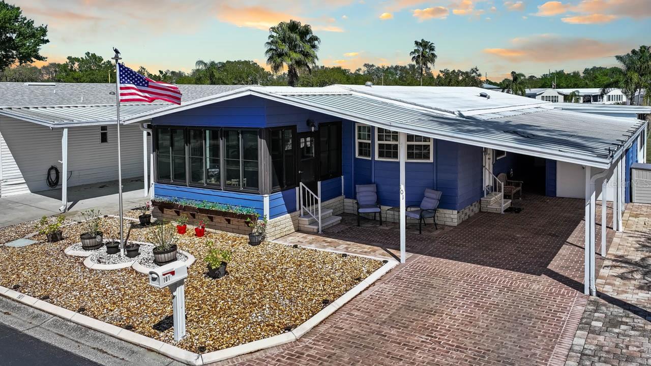 Welcome to relaxed Florida living in the highly sought-after 55+ Caribbean Isles Residential Cooperative, where this beautifully maintained 2-bedroom, 2-bath home offers both comfort and character with thoughtful upgrades throughout. A spacious bonus room provides the perfect setting for a family room, hobby space, or man cave, featuring a stunning window wall that frames peaceful views of the serene pond and lighted fountain just beyond your backyard. The updated kitchen is both functional and inviting, complete with a window over the sink, while the dining area showcases a built-in cabinet adding charm and practical storage. Custom woodworking details elevate the interior, including framed windows and hallway wainscoting, complemented by neutral paint and special decorative touches that create a warm, welcoming feel. This home comes fully furnished and move-in ready, with laminate flooring throughout for easy care, ceiling fans, and walk-in closets in both bedrooms, along with a built-in Murphy bed for added flexibility. The primary bath features a walk-in shower for convenience. Outdoor spaces are just as inviting, with a screened and enclosed front porch, a pavered front entry, and a rear paver patio overlooking the tranquil water—perfect for morning coffee or evening relaxation. A large storage shed provides additional space for tools or hobbies. Ideally located on a quiet court with no drive-through traffic, the home is just steps from the beautifully landscaped gazebo park and a short golf cart ride to the community’s resort-style amenities. Offering no lot rent and a low monthly maintenance fee, Caribbean Isles delivers an active yet peaceful waterfront lifestyle that is hard to match.