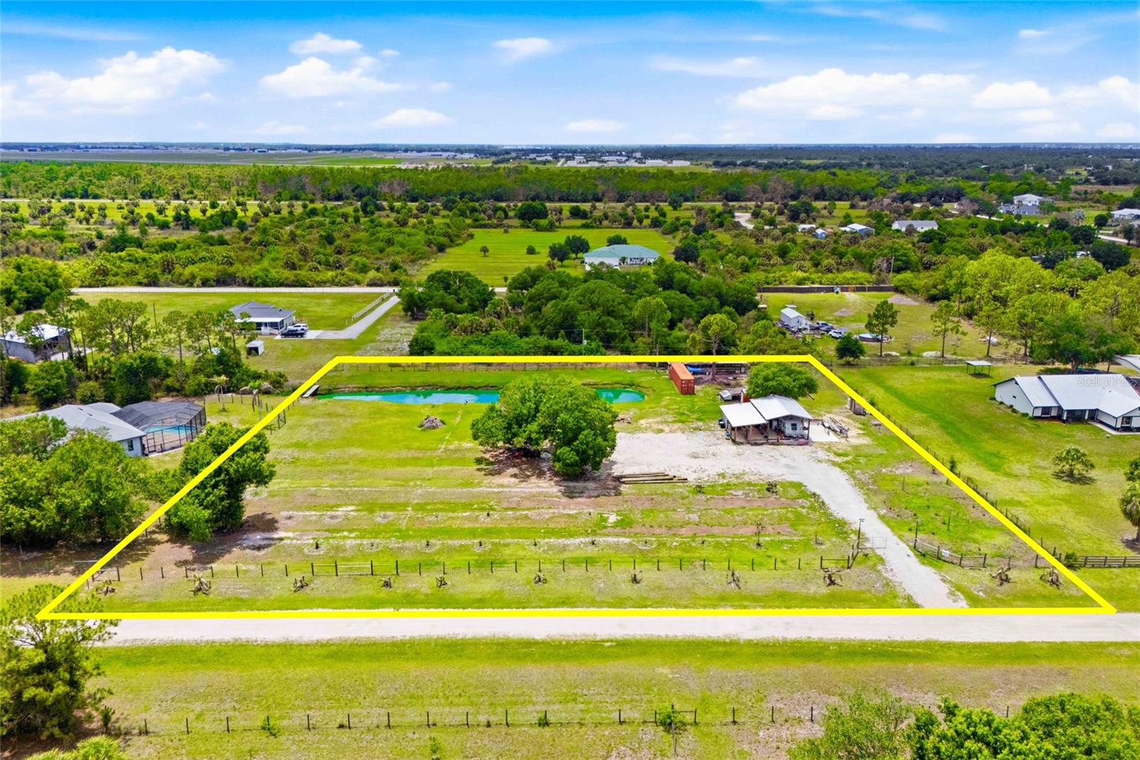 Premier real estate opportunity located at 7073 Alfred Blvd in the unique and desirable Charlotte Ranchettes of Punta Gorda, Florida. This 2.5-acre AG-zoned parcel is cleared, fenced, and ready for an aspiring homesteader, small-scale farmer or anyone looking to build a custom home and pool with plenty of space to enjoy peaceful living and have nearby access to downtown historic Punta Gorda.

The property is equipped with significant infrastructure. Electric service is already in place with cable readily accessible. A shallow well with a water treatment system provides water access, and irrigation has been established for watering fruit trees.
The property features a pole barn with a concrete slab, a chicken coop, a solid pen for small livestock animals, and a shipping container enclosed to provide secure storage for a tractor/lawn mower and other farm supplies. Fill dirt has been brought in as a foundation for the driveway and future home pad.

Zoned AG-agricultural, horses and livestock are welcome. No HOA or deed restrictions. For peace of mind the property is located in Flood Zone X, no flood insurance required and a potential insurance savings.
Situated just 15 minutes from downtown historic Punta Gorda and close to I-75, this location offers the perfect balance of rural tranquility and easy access to shopping, dining, golfing, schools, Gulf Coast beaches and the Punta Gorda Airport.

Whether you are looking to establish a hobby farm, a family homestead, or a future investment in a growing community, this property is full of potential and ready for its next chapter.