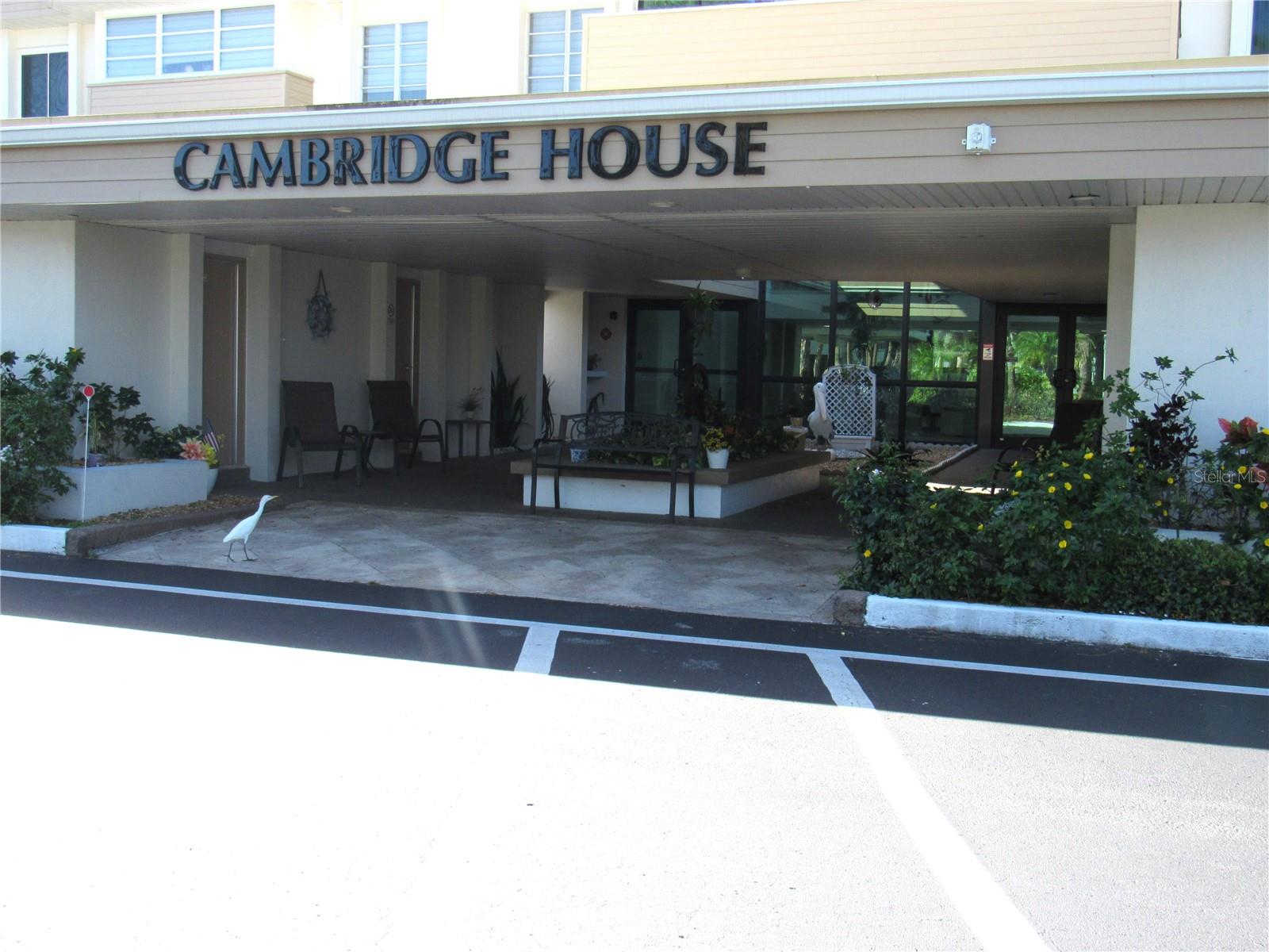 Well maintained and move-in ready, this turnkey, beautifully furnished 2-bed, 2-bath condo in Charlotte Square’s Cambridge House offers an easy, comfortable layout. The kitchen has been completely updated with wood cabinetry, granite counters, tile backsplash, newer appliances and is open to the dining and living rooms. The ensuite primary bedroom bath and guest baths both include tub/shower combinations and have been updated.  The bonus room, accessible by sliders from the living room, adds flexible space for seating, an office, or a den. Convenience is a plus with a large laundry room and a resident gathering room, with kitchen, which is available to the residents for social activities. Both are on the 3rd floor (accessible by elevator), plus there is a secured first-floor storage room and covered parking included with this unit. This active 55+ community offers two heated pools, tennis and pickleball, shuffleboard, bocce, and outdoor grilling areas.  Additional updates include IMPACT WINDOWS, a new electrical panel (2019), water heater (2018), and A/C (2018).  The building has been updated including a newer roof in  2023, A/C, new hallway flooring, and fresh interior paint. Water, sewer, exterior insurance, grounds and pool maintenance are included in the condo fee. All this and just a short distance to the library, shopping, restaurants and medical facilities. Schedule your private showing today.!