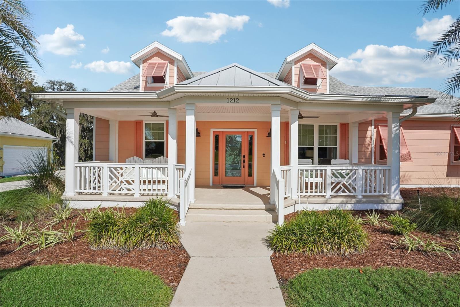 Virtually Staged. Live the Florida lifestyle you've been dreaming of in this charming Key West-inspired, partially furnished, solar home, perfectly situated just outside The Villages. Enjoy easy access to endless shopping, dining, golf, and entertainment while avoiding the traffic and age restrictions.

This inviting 3-bedroom, 2-bath home offers 1,722 square feet of beautifully appointed living space, plus an oversized side-entry 2-car garage. Start your mornings on the welcoming front porch overlooking lush landscaping, then unwind in the enclosed lanai facing majestic oak trees.

Inside, you'll love the bright, open feel created by soaring 10-foot ceilings, crown molding, custom wooden cornices, and easy-care laminate flooring throughout, with cozy carpet in one guest bedroom. The stylish kitchen shines with shaker cabinetry, quartz countertops, stainless steel Energy Star appliances, pull-out drawers, and a breakfast bar that's perfect for gathering with family and friends. Both bathrooms feature durable Corian countertops.

Designed to save you money without sacrificing comfort, this home includes owned solar panels, spray foam insulation, LED lighting, low-flush toilets, and Energy Star appliances, keeping average electric bills around an incredible $35 per month. A standout feature is the spacious walk-up attic, offering abundant climate-controlled storage while housing the HVAC system and water heater for added efficiency and convenience.

When you're ready to venture out, you'll enjoy resort-style community amenities including a wade-in pool, pickleball and tennis courts, basketball court, dog park, community garden, and a picturesque park with a water feature and fire pit. With year-round social events and friendly neighbors, you'll feel right at home from day one.

Beautifully maintained, exceptionally efficient, and full of coastal charm—this is Florida living at its best!  Schedule your private showing today!