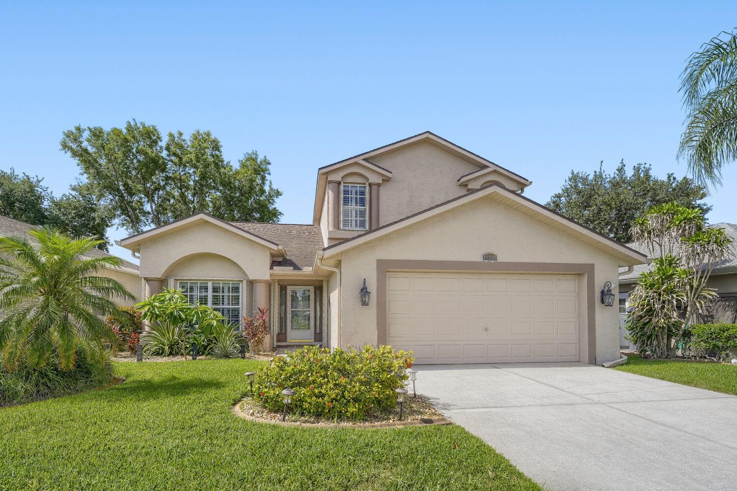 Here it is! your spacious, stately home in the best location in the community, with broad open space out back, and a serene pond view, inside the gated River Ridge Country Club. This prime location offers walking-distance proximity to River Ridge middle and high schools, via the back gate, quick access to the Suncoast Parkway, and a short 30-minute drive to Tampa International Airport. Inside, the open-concept floor plan boasts vaulted ceilings, abundant natural light, and custom white plantation shutters. The main floor features durable wood-look porcelain tile. Premium kitchen features granite countertops, stainless steel appliances, double oven, bright eat-in space as well as a granite, bar-height breakfast counter. Primary suite features a large walk-in closet with custom built-ins. Extra large under-stair storage closet in generous bathroom, with dual-vanity, soaker tub and stand-up shower. Upstairs, a versatile loft accompanies two additional bedrooms and a full hall bath. Relax on the screened lanai or paver patio to enjoy the picturesque view. Everyday peace of mind with built-in sliding hurricane shutters. Bonus updates include a dual-zone AC, a whole-house carbon filter water purification system with a softener, a hybrid water heater (2019), and newer roof (2019). Best of all, there are no CDD fees, and the low HOA covers all lawn care, irrigation, fertilization, pest control, and trash removal. Come get it before it's gone!