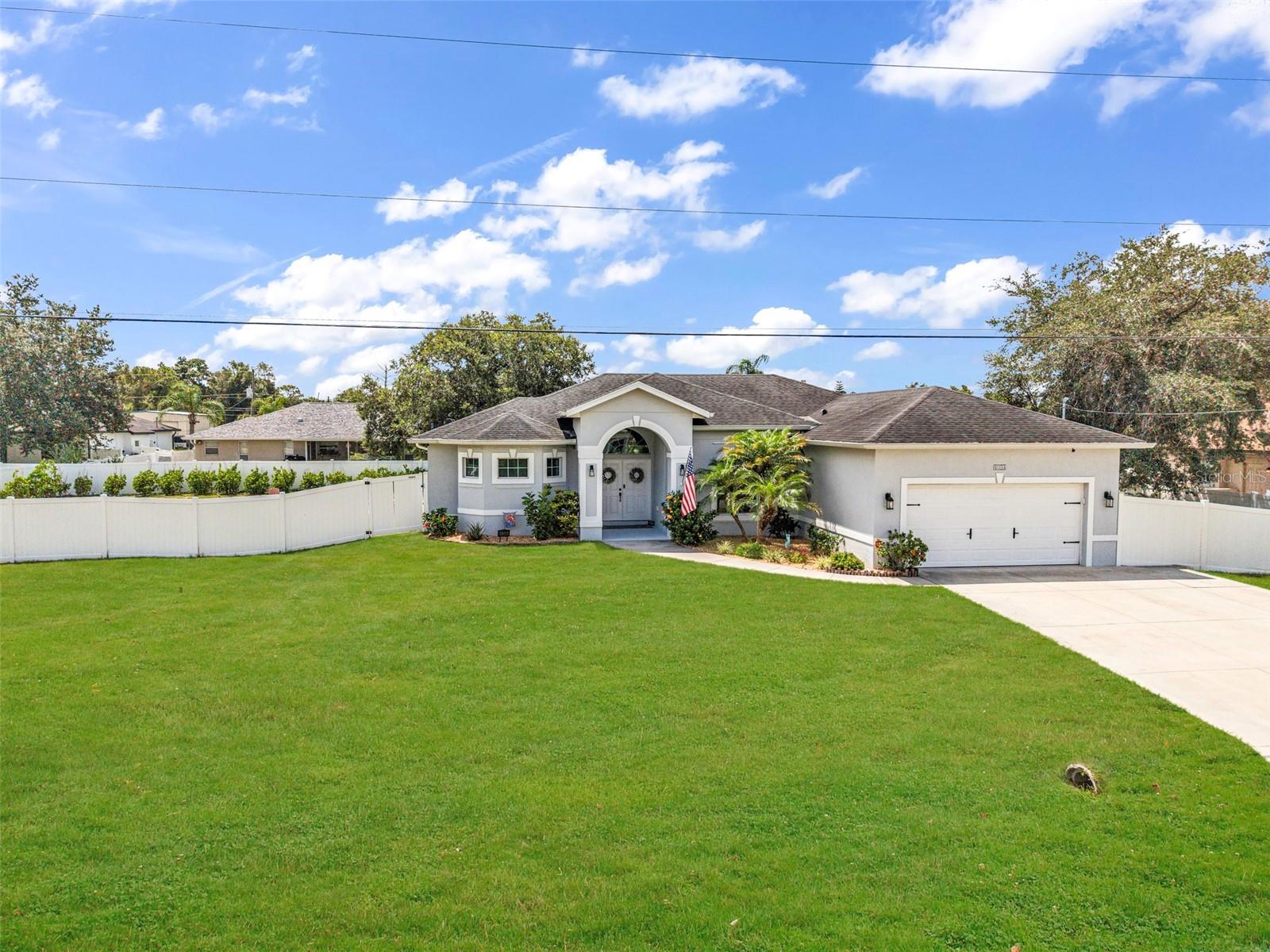 Welcome to this beautifully maintained 3-bedroom, 2-bathroom home with a 2-car garage, offering 1,956 square feet of living space under air. Built in 2017 and situated on a rare DOUBLE LOT this exceptional  property features a HEATED SALTWATER POOL, WHOLE HOUSE RO, numerous UPGRADES, and outstanding indoor-outdoor living. From the moment you arrive, you’ll appreciate the mature landscaping and decorative stone curbing, and inviting curb appeal. Double French doors open to a spacious, open-concept floor plan featuring tile flooring throughout the main living areas and plush carpeting in the guest bedrooms. The formal dining room is currently utilized as a home office, offering flexibility to suit your lifestyle. The expansive living room showcases pocket sliding glass doors that seamlessly blend indoor and outdoor living spaces. Designed with both style and functionality in mind, the kitchen features soft-close cabinetry, granite countertops, recessed lighting, a breakfast bar, closet pantry, and a sunny breakfast nook with sliding doors leading to the lanai. The interior laundry room provides additional storage with extra cabinetry, a utility sink, and a storage closet. The washer and dryer are included. The spacious primary suite offers new wood-plank tile flooring, dual walk-in closets, and private sliding-door access to the pool area. The luxurious en-suite bathroom features dual vanities with freshly painted soft-close cabinetry, granite countertops, elegant gold fixtures, a garden soaking tub, a tiled Roman walk-through shower, and a linen closet. Two generously sized guest bedrooms feature built-in closets and new light fixtures and share a full guest bathroom with a single vanity and tub/shower combination. Step outside to your private backyard retreat. The screened and extended paver lanai surrounds a heated saltwater pool complete with a sun shelf and waterfall & fountain feature, creating the perfect setting for relaxing or entertaining. The FULLY FENCED backyard offers privacy and is beautifully landscaped outdoor space. Additional updates include a Whole-House Reverse Osmosis system, Updated light fixtures/fans throughout, Interior paint, Fridge, Dishwasher and Washer replaced in (2025) and Water Heater (2026), and a NEW A/C system (2024). Equipped with hurricane shutters for peace of mind. With no HOA, no deed restrictions, and located outside of a flood zone, this move-in-ready home truly has it all. This home is conveniently located in a nice neighborhood but close to restaurants, shopping, beaches and much more, this home is a must-see! Schedule your appointment today and make it yours!