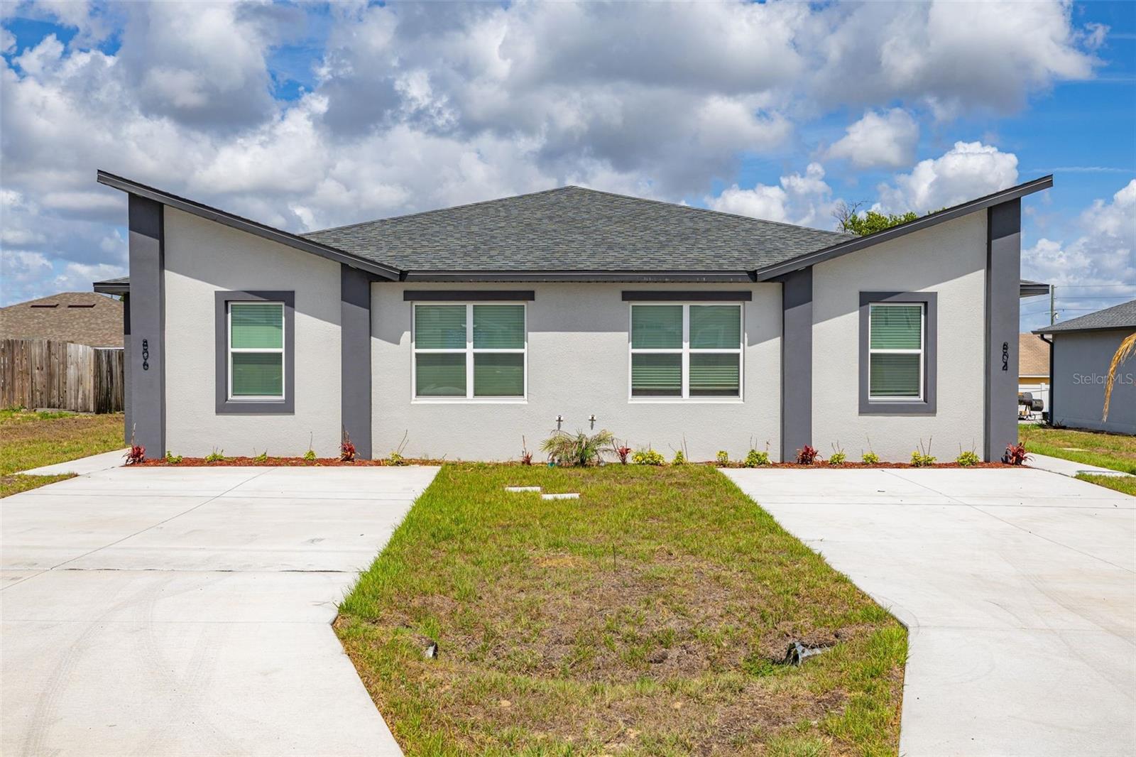 Exceptional opportunity to own a newly constructed full duplex with high-end finishes in the amenity-rich Poinciana Villages community. Built in 2025, property features two spacious units with a combined 2,576 square feet of living space, offering a total of 6 bedrooms and 4 bathrooms. Designed with luxury modern finishes throughout, each unit includes high-end flooring, multiple ceiling fans, walk-in closets in the primary bedrooms, and thoughtfully upgraded kitchens with soft-close cabinetry, premium hardware, and brand-new stainless-steel appliances. New washer and dryer sets are included in each unit. The primary bathrooms feature dual sinks, tiled showers, and glass-enclosed walk-in showers. Additional highlights include covered entries and extended driveways, providing convenience and curb appeal. Whether expanding an investment portfolio or seeking the flexibility of owner-occupied living with rental income potential, this duplex offers a versatile opportunity in a well-established community with a variety of recreational amenities.