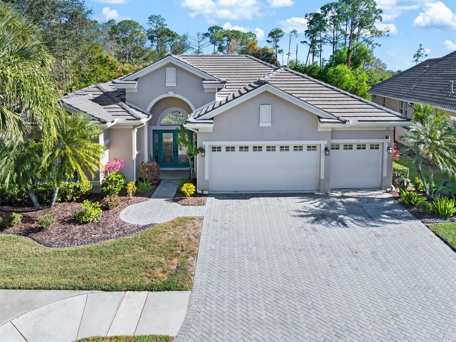 Luxury, Lifestyle, and one of the most convenient locations in Heron Creek Golf & Country Club come together in this beautifully designed 4 bd., 3 bath home with a 3 car garage, Heated Pool & Spa. Offering over 2600 sq. ft. of refined living space, this home is positioned within the community for easy in and easy out access! Step inside and you will immediately notice how quiet & peaceful the home feels, creating a environment that feels removed from the outside world. This prime positioning keeps you just moments from major roadways, shopping, dining & everything Florida has to offer, allowing you to spend less time driving an more time enjoying your home & lifestyle. A New Tile roof installed in 2023 and New AC system provide comfort, efficiency and long term value. Curb appeal makes a strong first impression with a brick paver driveway & walkway that lead to the double leaded glass entry doors. Inside, the spacious layout is enhanced by pillared columns, crown molding, and custom plantation shutters. Natural light fills the space while the interior design creates a sense of calm and privacy. making it easy to relax. Triple sliding glass doors open wide to the Pool & Spa, blending the indoor & outdoor living into one. The screened lanai & pool area offer a private retreat with outside kitchen! The kitchen takes center stage with upgraded Granite center island, a generous breakfast bar, & wood cabinetry accented with crown molding. A tiled backsplash, recessed lighting, and 2 pantries add style. SS appliances, including refrigerator, dishwasher, & microwave,(2yr). A charming breakfast nook overlooks the lanai, adding to the home's inviting atmosphere. The primary suite continues the sense of tranquility with a quiet, retreat like feel, featuring 2 large walk-in-in closets with built organizers. The ensuite bath includes a spacious walk-in shower, a luxury garden tub framed by decorative columns, & dual sinks, creating a spa-like environment. Guest bds. provide ample space, large closets, & ceiling fans, while the 4th bd. is currently used as a den/office. The Utility room includes Washer & Dryer, built in Sink and Shelving. Outside, the screened Paver Pool & Spa with Outdoor Kitchen create a private setting for gatherings. The insulated garage is air-conditioned & elevates the home, offering a true extension of the living space. Designed with functionality in mind, this Climate Controlled environment features an Epoxy floor, polished Showroom style appearance. 2 Electronic Overhead Storage Lifts maximize space while keeping everything organized and out of sight, and a built-in Work Bench with Dual Storage Cabinets provides room for projects, hobbies & work space. Perfect for car enthusiasts, home gym, workshop, or storage, this garage delivers a versatility and is high end! Extras include: mold preventative lights, Ring doorbell, Cameras & newer hot water heater. Enjoy maintenance free lifestyle with HOA fees covering water/sewer/cable/internet/lawn care/irrigation & security. Enjoy the Clubhouse, restaurant, fitness, tennis, resort style pool & spa, optional golf memberships on a 27-hole Arthur Hills course. Easy access to I-75, shopping, restaurants, the new SMH hospital being built & 20 min. to Gulf beaches!