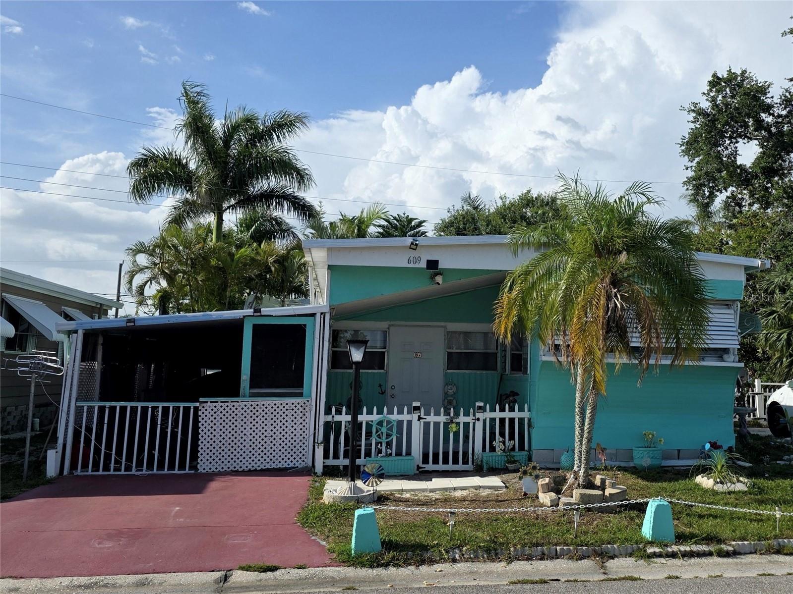 55+ FAIR LANE ACRES - YOU OWN THE LOT! No lot rent. $135 a month HOA includes water, community pool, activities, and more! Welcome to easy Florida living in this charming 2 bedroom home located in a desirable 55 plus community where you own your land and enjoy a low HOA of just $135 a month with no lot rent.

This single wide home offers extra living space with an enclosed Florida room, perfect for relaxing or entertaining year round. A covered carport provides convenient parking and additional shade, while the spacious backyard offers plenty of room to garden, unwind, or enjoy the outdoors.

Inside, you will find a newly updated bathroom and a fresh coat of paint throughout, giving the home a clean and inviting feel. The layout is functional and comfortable, with great potential for a buyer looking to add their own personal touches and updates. Furniture is included, so move in and get comfortable! 

The community features a sparkling clean pool, shuffleboard courts, pickleball, and an active clubhouse with planned activities, making it easy to enjoy a vibrant and social lifestyle. Conveniently located just eight miles from the beach and close to shopping, dining, and everyday essentials, this home offers both relaxation and accessibility. 

Whether you are looking for a seasonal retreat or a full time residence, this property offers affordability, ownership of land, and a welcoming community atmosphere.

Come see the potential and make it your own.