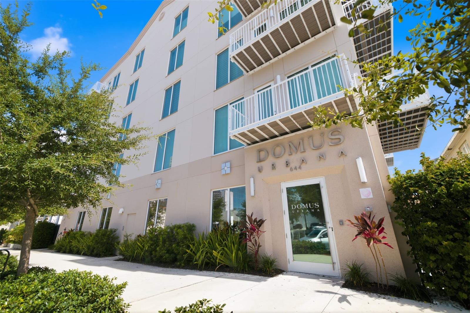 Welcome to Domus Urbana, one of downtown St. Petersburg's most desirable boutique condominium communities. Built in 2023, this beautifully designed 2-bedroom, 2-bathroom residence offers 1,355 square feet of thoughtfully crafted living space, soaring 10-foot ceilings, and an open-concept floor plan that feels bright, spacious, and inviting from the moment you step inside.

At the heart of the home, the contemporary kitchen is designed for both everyday living and effortless entertaining. Featuring quartz countertops, premium Bosch stainless steel appliances, sleek cabinetry, and an oversized island overlooking the living and dining areas, the space flows seamlessly together to create a warm and welcoming atmosphere. Just off the living room, a private balcony offers the perfect spot to enjoy your morning coffee, unwind after a busy day, or take in the vibrant energy of downtown St. Petersburg.

The thoughtfully designed split-bedroom layout provides comfort and privacy for both owners and guests. The spacious primary suite features a walk-in closet and a beautifully appointed en-suite bathroom, while the generous guest bedroom also enjoys access to its own full bathroom, making it ideal for visitors, a roommate, or a private home office. A dedicated laundry room with a Samsung washer and dryer, along with an oversized interior storage closet, offers the convenience and functionality rarely found in condominium living.

Additional highlights include one secured, covered parking space equipped with an electric vehicle charger, secure building access, bike storage, and the added peace of mind of being located in Flood Zone X and non-evacuation zone—a valuable advantage for downtown living.

Residents of Domus Urbana enjoy an impressive collection of amenities including a fitness center, resident clubhouse with a full kitchen, indoor and outdoor gathering spaces, dog run, and dog wash station, creating the perfect balance of convenience, community, and lifestyle.

Location is everything, and this home places you in the center of it all. Just blocks from Central Avenue, you'll enjoy easy access to award-winning restaurants, breweries, coffee shops, boutiques, museums, art galleries, and vibrant nightlife. Spend weekends exploring the St. Pete Pier, cheering on the Rays at Tropicana Field, attending concerts at the Mahaffey Theater, catching a Rowdies match at Al Lang Stadium, or strolling along the waterfront parks that have made St. Petersburg one of Florida's most celebrated cities.

Commuters and travelers will appreciate the quick access to I-275, putting Tampa International Airport and St. Pete-Clearwater International Airport within approximately 30 minutes. The area's award-winning Gulf beaches are also just a short drive away, making it easy to enjoy everything the Tampa Bay lifestyle has to offer.

Whether you're looking for a full-time residence, a seasonal escape, or a lock-and-leave lifestyle close to the best dining, entertainment, and waterfront attractions in the city, this exceptional home offers the perfect combination of modern design, low-maintenance living, and an unbeatable downtown location.