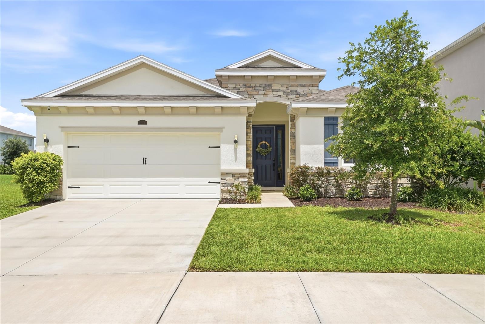 Welcome to this stunning 2021-built, one-story home with an incredible water view and no rear neighbors! This 4-bedroom, 2.5-bathroom home with a 2-car garage showcases thoughtful design and premium upgrades. The kitchen features upgraded appliances and includes  a custom-built pantry with a convenient work counter. The home features Deako, Plug-n-Play lights switches, a modular switch system enabling customization without rewiring. The primary bedroom offers two walk-in closets with built-in shelving and an amazing water view. The home is fitted with versatile window treatments that open from both the top and bottom. Enjoy outdoor living with a fence and screened patio equipped with nano wiring to keep bugs and pollen out.  The kitchen and bathrooms boast matching granite countertops, and all door handles and hinges have been upgraded.  Preserve is a beautiful community in a highly desired area of Tampa Bay that offers its residents a relaxing lifestyle with high-end amenities, including a clubhouse, a heated pool and lap pool, tot lot, sports fields, dog park, walking trails, and scenic ponds, all while being near shopping, dining, and the area’s top schools.The Ring security system and water filtration system are included.