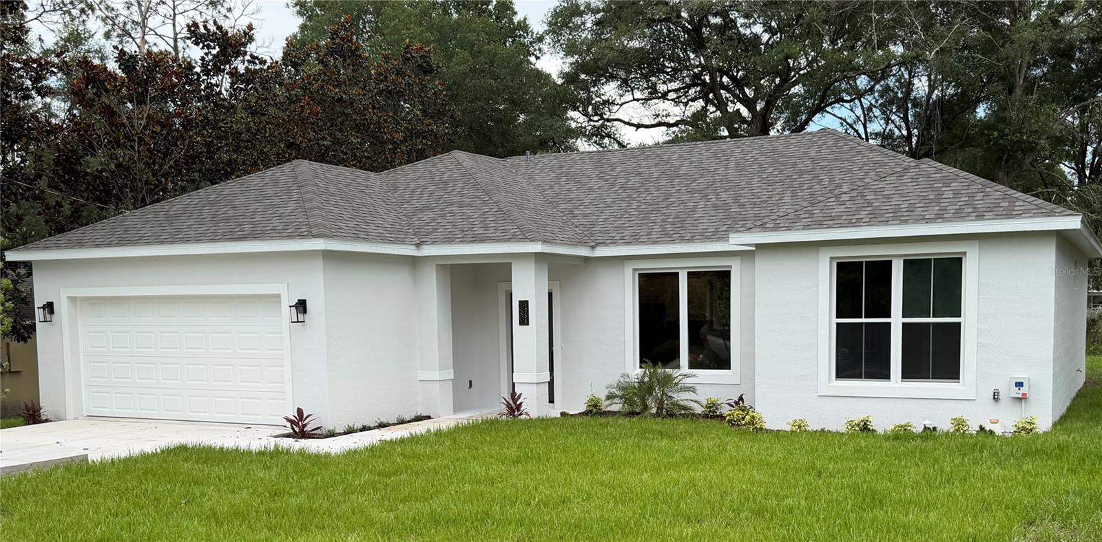 NEW BUILD!! NOW is YOUR time!! This beautiful new home is located in a quiet neighborhood with no HOA fees! Perfectly nestled on a quiet street, you'll be wanting to call this 1,530 square foot, 3/2 split floor plan "Home Sweet Home!" The main living area is open to the kitchen and boasts soaring ceilings that provide a spacious, open feel. The gorgeous kitchen includes stainless-steel appliances, 42" cabinets and a granite-topped island. The Owner's Suite features a large walk-in closet and the private bathroom includes a step-in shower with custom tile and a large corner soaking tub. Additional features include ceiling fans in all bedrooms and living area. Don't miss this incredible opportunity!