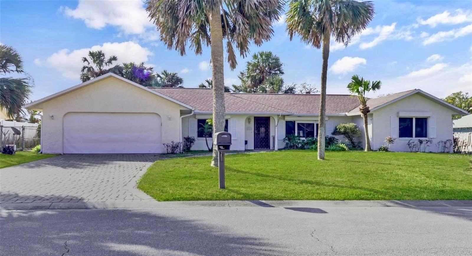 One or more photo(s) has been virtually staged. Some pictures have been virtually staged. Beautiful beachside retreat located high on a hill, in the serene and sought-after community of Ponce Inlet. This spacious 3-bedroom, 2-bathroom home spans 1,912 sq ft and sits on a spacious 0.29-acre lot, offering the perfect combination of luxury, comfort, and peace of mind. Never flooded and built on high, dry ground. Step inside and fall in love with the bright, open floor plan, featuring a welcoming living room with a cozy wood-burning fireplace, a separate family room, and a chef-inspired kitchen with stunning quartz countertops, perfect for entertaining or family gatherings. The primary suite serves as a true retreat, complete with tiled marble flooring, ensuite bathroom and a large walk-in closet, blending elegance with functionality. Your personal outdoor oasis awaits, an expansive screened-in pool and lanai area ideal for relaxing afternoons or evening get-togethers. The fully fenced backyard ensures privacy, safety, and ample space for pets or play. Just 3 blocks from the beach and 1 block from the Intracoastal, you’ll enjoy effortless access to sun-kissed shores, restaurants, marinas, and boating adventures. Walk to the iconic Ponce Inlet Lighthouse, dine at the beloved Hidden Treasure Rum Bar & Grill, or catch a sunset and live music at Off The Hook at Inlet Harbor, all just minutes away. Whether you're looking for a full-time residence or a vacation escape, this home delivers the perfect blend of coastal charm, modern comfort, and unbeatable location.