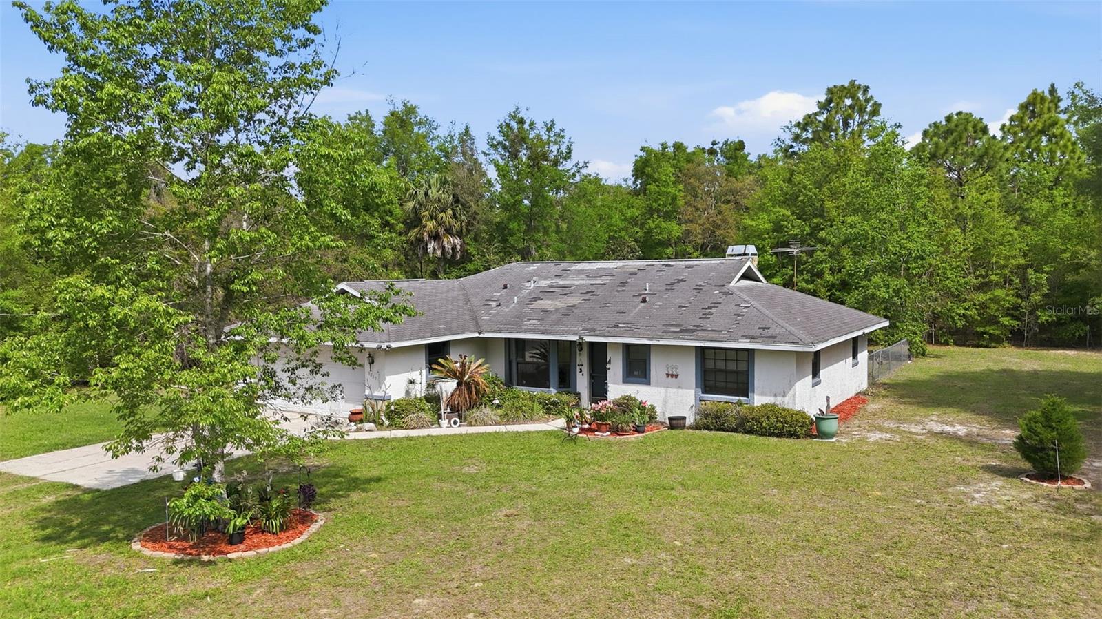 Opportunity awaits on this 6.23-acre property in Lecanto, FL, offering the perfect blend of privacy, space, and convenience. Located just minutes from shopping, dining, and the Lecanto medical corridor, this property is amazing for buyers seeking acreage near town without the restrictions of a subdivision. The home features a spacious 3-bedroom, 2-bathroom split floor plan with a 2-car garage. Inside, you’ll find a large great room with a cozy fireplace, vaulted ceilings, and direct access to a screened lanai. This 2042 sqft home is in need of updates, making it a great option for investors, cash buyers, or those looking for a renovation project. With over 6 acres of usable land, there is plenty of room for a mini farm, horses, RVs, workshop, or future new construction. Properties with this amount of land in central Lecanto are becoming increasingly rare. Whether you're looking to rehab, rebuild, or invest in land, this property offers outstanding potential in a highly desirable and growing area. No HOA. No deed restrictions. Endless possibilities. Major bonus for buyers—seller will install a new roof with an acceptable offer, making this home move-in ready and worry-free.
