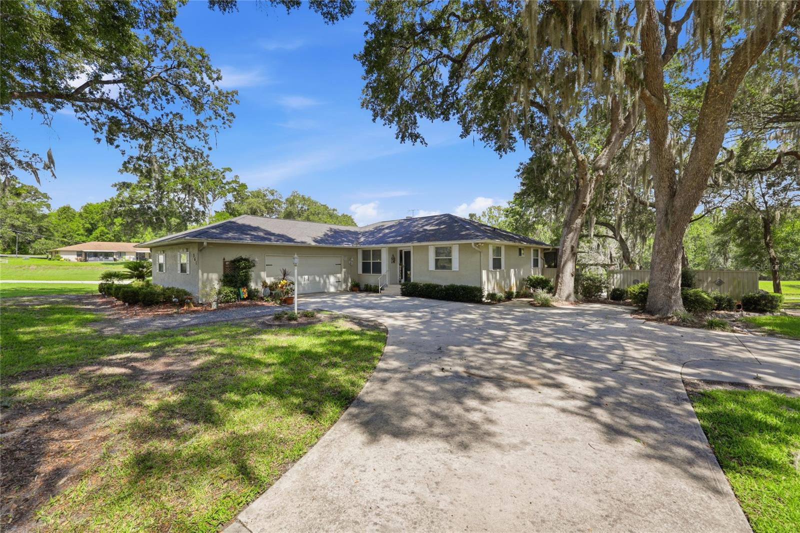 Welcome to a truly one-of-a-kind waterfront retreat in the heart of Lake Geneva Estates in beautiful Melrose, Florida—where everyday living feels like a private getaway.

This exceptional 3-bedroom, 2-bath canal-front home offers something rarely found: sweeping water views paired with your very own 8.24-acre island included in the sale. From the moment you arrive, the paved driveway leads you to an inviting entrance that sets the tone for what’s inside.

Step through the door into a spacious open-concept living area where high ceilings and a panoramic layout seamlessly connect the living room, kitchen, and dining space. The kitchen is designed for both function and gathering, featuring abundant counter space and sleek stainless steel appliances. Anchoring the living room is a warm brick wood-burning fireplace, creating a cozy focal point that flows naturally into the Florida room—where walls of windows showcase stunning canal and island views.

The primary suite is a peaceful retreat with a generous walk-in closet and a private en-suite bath. An interior utility room adds everyday convenience and functionality.

Outdoor living is where this property truly shines. An oversized garage provides ample storage, while the screened lanai invites you to relax and take in serene views of the island just beyond your backyard. A patio overlooks lush green grass leading directly to your private island entrance—your own natural sanctuary waiting to be explored.

The island itself is an oasis, complete with two RV hookups and a charming mini clubhouse with covered gathering space—perfect for entertaining, camping-style weekends, or hosting unforgettable get-togethers. Nature surrounds you here, with frequent sightings of whistling wood ducks, sandhill cranes, deer, and more, creating a peaceful and vibrant wildlife backdrop.

Tucked away in a quiet, desirable neighborhood, this property offers the rare combination of privacy, acreage, waterfront living, and convenience—just minutes from local restaurants, shopping, and everyday essentials. And best of all—NO HOA.

Offered at $497,500, this is more than a home—it’s a lifestyle, a retreat, and an extraordinary opportunity to own a slice of Florida paradise.