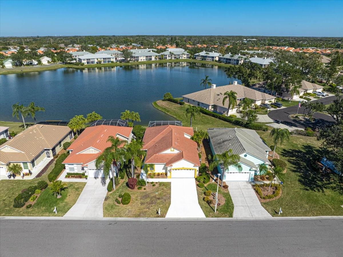 Welcome to this lakefront patio home in the desirable Peridia Isle community, featuring one of the larger floorplans at approximately 1,840 square feet. Offering 2BR, 2BA plus a versatile den, the home provides a well-planned layout ideal for comfortable everyday living and entertaining, enhanced by volume ceilings that create a light and open feel. Enjoy tranquil lake views through New Panoramic lanai screens, adding to the home’s serene and inviting setting. The kitchen features granite countertops, a New dishwasher & New refrigerator and opens seamlessly to the dining and living areas. Both bathrooms have been updated with New countertops, New toilets, and New faucets. The primary suite includes a walk-in closet, dual sinks, and a walk-in shower, while a second bedroom at the front of the home provides privacy for guests. The den offers flexible use as a home office or additional guest space. An interior laundry/utility room adds convenience. Recent improvements include a newer roof (01/2022), A/C system (01/2021), full replacement of ductwork within the last few years, and a whole-house air purifier for enhanced indoor air quality. The back lanai floor, walkway, and driveway have been freshly painted. The property also includes a spa that is currently not operational but may be restored. The garage offers additional storage with extra built-in cabinets and countertops. Located within Peridia Golf & Country Club, residents have access to a golf course, clubhouse, swimming pool, tennis courts, pickleball, a Tiki bar, and on-site dining, along with a variety of social and recreational activities available within the community. One-time capital reserve of $4,000 due at closing. Master Association-$938 Quarterly, Yard maintenance- 455 Quarterly. Annual Food/beverage Minimum- $600. One-time application fee of $200 is required for new residents.