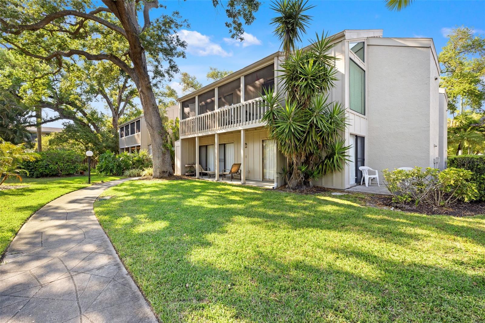 Location, charm, and opportunity come together in this truly one-of-a-kind condominium in Cordova Gardens. Tucked among lush greenery just minutes from downtown Sarasota and the world-famous beaches of Siesta Key, this cozy “treehouse” residence offers the perfect blend of privacy, character, and potential—ideal as a personal retreat or an income-producing property.

Set on the second level, this 2-bedroom condo welcomes you with warm wood accents, including beautiful cedar stairs that add to its inviting, natural feel. The standout feature is the unique upstairs loft—one of the few in the community—complete with two large storage closets, making it perfect for a home office, creative space, or additional lounge area.

Natural light pours in from every angle, with sliding glass doors and windows framing tranquil treetop views that give the home its signature treehouse ambiance. Multiple screened balconies off the bedrooms, living room, and kitchen create a seamless indoor-outdoor flow, allowing you to enjoy gentle breezes and peaceful surroundings throughout the day.

The kitchen features newer stainless steel appliances, offering a modern head start for your own design vision. With a little creativity, this space can easily be transformed into a stylish, photo-worthy retreat with a downtown loft vibe.

Cordova Gardens is a small, quiet, and friendly community ideally located just about a mile from downtown Sarasota and the North Bridge to Siesta Key. Enjoy convenient access to shopping, dining, arts, and entertainment—while still coming home to a peaceful, tucked-away setting.