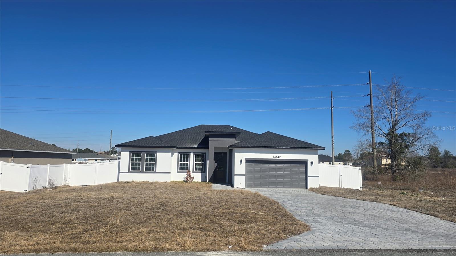 New construction, never occupied, under the builder's warranty, surrounded by a brand-new fence. Nestled in the sought-after Unit 01 of Marion Oaks, this brand-new residence blends contemporary design with timeless elegance. From the moment you step through the impressive 8-foot front door, you’ll be greeted by an airy, open floor plan with soaring 9-foot ceilings, luxurious vinyl plank flooring, and premium finishes throughout. The gourmet kitchen is a true showpiece — featuring stunning quartz countertops with a striking waterfall island, 42-inch custom wood cabinetry, and sleek stainless steel appliances. It’s designed for both functionality and style, making it the perfect centerpiece for entertaining family and friends. Each bathroom showcases meticulous attention to detail, with floor-to-ceiling tile in the shower areas and modern fixtures that exude sophistication. The expansive primary suite offers a tranquil retreat, complete with a generous walk-in closet and a spa-inspired bathroom featuring dual vanities, a freestanding soaking tub, and a spacious glass-enclosed shower. Experience the comfort, quality, and peace of mind of a brand-new home — all backed by the builder’s full home warranty. Discover refined living in the desirable Marion Oaks community and schedule your private showing today.