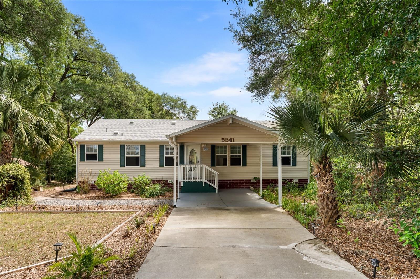 It’s the details that truly set this one apart. This beautifully upgraded 3-bedroom, 2-bath custom modular home offers a refined yet comfortable living experience, thoughtfully enhanced throughout. Inside, you’ll find new flooring with sealed edges, elegant marble window sills, Porcelain countertops, double-pane windows, and a custom interior paint palette that creates a clean, modern feel. A security system is already in place, while a concrete driveway and covered 1-car carport add everyday convenience.

Step outside and discover a property that goes far beyond the ordinary. The grounds have been intentionally designed and meticulously maintained, featuring a thriving collection of over a dozen fruiting trees. Perfect for those who appreciate horticulture, sustainability, and a lifestyle connected to nature.

Situated on two separately parceled and surveyed lots, this property offers flexibility and future potential. One lot is cleared and shaded by mature oak trees, while both enjoy a peaceful setting near Moon Lake, where steady breezes create a refreshing, almost coastal atmosphere. The expansive backyard provides ample space to expand gardens, add additional structures, or simply enjoy the privacy and open surroundings. Zoned R-1, the property allows for a primary residence with the potential for a mother-in-law suite or additional living space.

Outdoor living is just as impressive, featuring a hot water soaking tub and outdoor shower that create a spa-like retreat right at home. A fully insulated “man cave” style shed with window A/C offers the perfect space for hobbies, a workshop, or a private office, along with two additional storage shed for tools and equipment.

Additional highlights include an assumable mortgage at low interest rate with an approximate balance of $190,000, and the property does not require flood insurance, offering added peace of mind.

If you’ve been searching for a property that blends comfort, character, and a true connection to the land—with room to grow, create, and unwind—this one delivers in all the right ways.