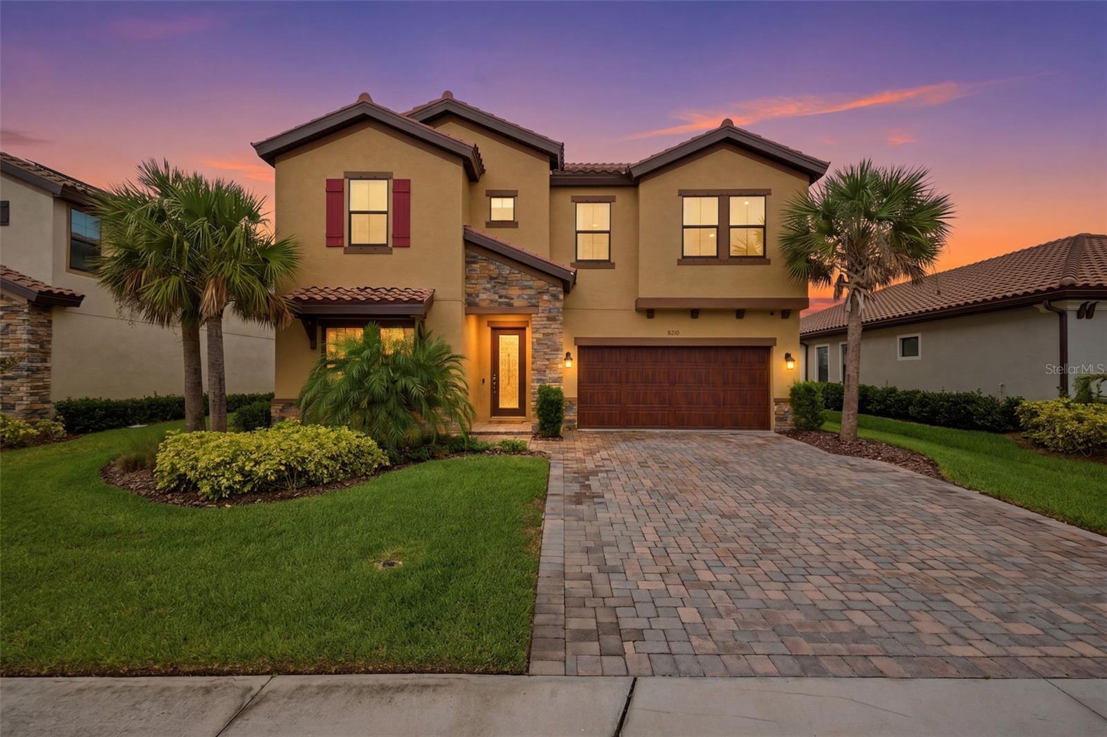 A rare opportunity in Crosswind Ranch — this 2023 Homes by Westbay residence pairs a premium pond-view lot with a rare to find floor plan the builder no longer offers. Set in Parrish, one of Florida's fastest-growing zip codes, the 3,410 sq ft two-story design delivers five bedrooms, three full baths, and a layout built for the way today's homeowners actually live.

A paver driveway and stone-accented elevation set the tone at the curb. Inside, wood-look tile flows uninterrupted across the entire first floor, anchoring a formal dining room, an open-concept great room, and a chef's kitchen thoughtfully upgraded throughout. The quartz-topped center island seats four; built-in wall ovens, a gas cooktop with vented hood, abundant cabinetry, and a generous walk-in pantry round out a kitchen built equally for weeknight ease and weekend entertaining. The adjacent breakfast nook frames floor-to-ceiling water views — and expansive sliders open the living room onto a screened lanai positioned to catch Florida sunsets over the pond.

A carpeted, first-floor guest bedroom, and full bath, a dedicated mud room, and a spacious office nook complete the main level — flexible space for visitors, work-from-home days, and everyday Florida living.

Upgraded luxury vinyl plank flooring carries up the staircase and across the second-floor common areas, including an oversized bonus room that doubles as a true second living space — perfect for a media room, game lounge, or kids' retreat. The owner's suite continues the upgraded LVP and serves as a private sanctuary, featuring a spa-inspired bath with a soaking garden tub, glass-enclosed walk-in shower, dual vanities, and an oversized walk-in closet. Three additional carpeted bedrooms, a second full bath with double-sink vanity, and a generously sized upstairs laundry room complete the second floor.

Throughout, the home is a study in considered elegance — light wood-look tile, espresso cabinetry, quartz surfaces, and designer brass lighting layered against a soft neutral palette. High ceilings, abundant natural light, and a wrought-iron entry door add architectural character, while every finish has been selected to feel both refined and effortlessly livable.

Residents of Crosswind Ranch enjoy resort-style amenities including a clubhouse, community pool, tennis and pickleball courts, dog park, and playground. The location places you minutes from Market Walk at North River Ranch — Publix, Foxtail Coffee, dining, and everyday services — with quick access to US-301 and I-75 connecting you to Lakewood Ranch, Sarasota, St. Petersburg, and Tampa. Zoned for top-rated Barbara A. Harvey Elementary/K-8 and Parrish Community High School.

A near-new Westbay home, a premium pond-view lot, and a floor plan the builder no longer offers — — this is the kind of Florida home that doesn't come back to market. Schedule your private tour today.