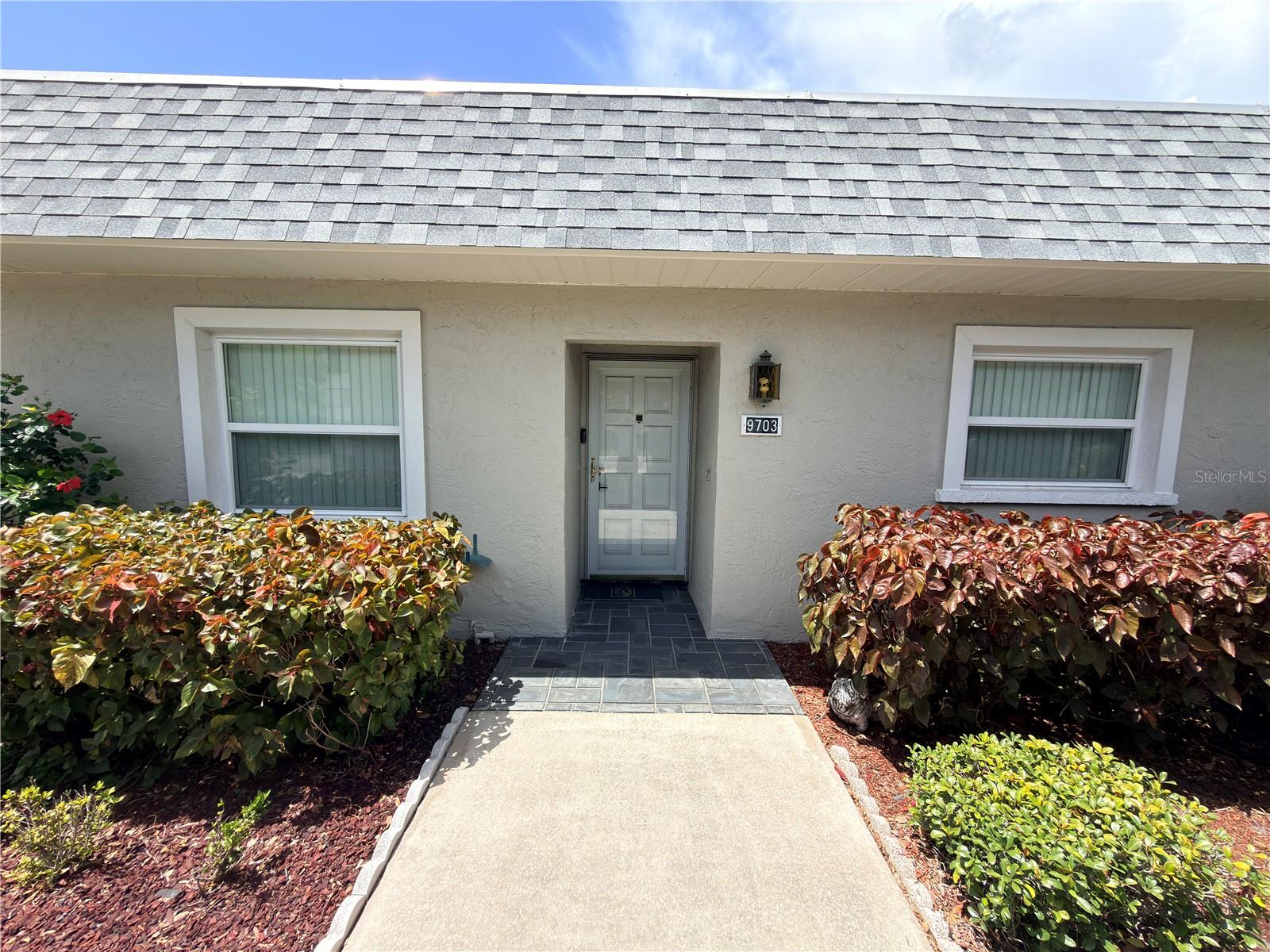 Nestled within the highly sought-after gated community of Seven Springs Golf & Country Club, this beautifully maintained 2-bedroom, 2-bathroom villa offers an exceptional opportunity to enjoy Florida living at its finest. A standout feature of this home is its location on the only street in the community that does not require the mandatory Club Social Fee, providing a significant financial advantage over many neighboring properties.

Step inside to discover a bright, open floor plan enhanced by brand-new laminate flooring, a new water heater, and an abundance of natural light. The spacious living and dining areas flow effortlessly, creating an inviting space for both everyday living and entertaining. The kitchen offers ample cabinet storage, generous counter space, and a cozy breakfast area, while the convenient indoor laundry closet adds everyday practicality.

The spacious primary suite features a walk-in closet, private en-suite bathroom, and dedicated dressing area, creating a comfortable retreat at the end of the day. A generously sized guest bedroom and full guest bathroom provide the perfect setup for visitors or flexible use as a home office or hobby room.

The true showstopper is the screened rear lanai overlooking one of the community's most picturesque golf course settings. Enjoy peaceful mornings and relaxing evenings surrounded by beautifully manicured landscaping and sweeping fairway views that create a serene backdrop year-round.

Seven Springs Golf & Country Club offers a gated lifestyle with convenient access to top-rated shopping, dining, healthcare, parks, and major roadways, while Florida's world-famous Gulf beaches and Tampa International Airport are all within an easy drive.

Whether you're searching for a full-time residence, seasonal getaway, or investment opportunity, this move-in-ready villa combines low-maintenance living, meaningful cost savings, tasteful updates, and an outstanding golf course setting that is difficult to match.