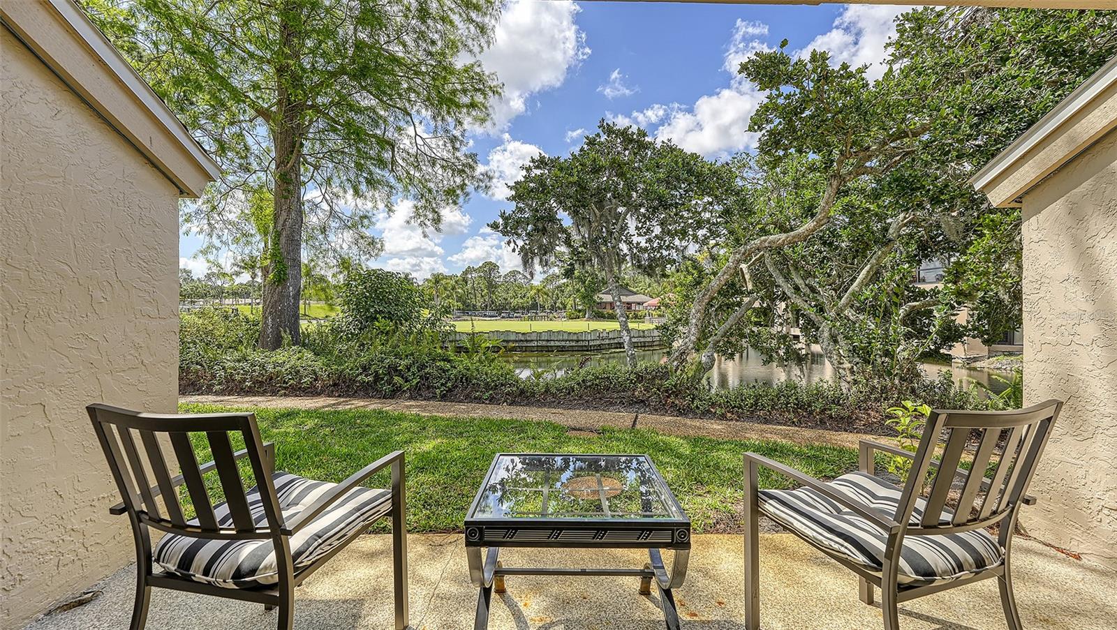 Beautifully renovated and offered fully furnished, this charming 1-bedroom, 1-bathroom ground-floor condominium is located in the highly desirable Meadows community. Featuring approximately 553 square feet of thoughtfully designed living space, the condo offers a bright open floor plan, tasteful furnishings, and a peaceful setting overlooking a pond, putting green, and mature landscaping. The updated kitchen is equipped with modern appliances and opens to a comfortable living area with large sliding glass doors leading to a private screened patio—an ideal place to relax and enjoy the tranquil views. The spacious bedroom features luxury vinyl flooring, a queen-size bed, and generous natural light, while the renovated bathroom includes a large walk-in shower. Additional features include an in-unit washer and dryer, assigned parking, and access to the community pool. The Meadows is renowned for its miles of scenic walking and biking trails, lush landscaping, and convenient location just minutes from UTC Mall, Benderson Park, Downtown Sarasota, and the world-famous beaches of Lido Key and Siesta Key. Whether you're looking for a primary residence, seasonal getaway, or investment opportunity, this move-in-ready condo offers comfort, convenience, and exceptional value in one of Sarasota's most established communities.