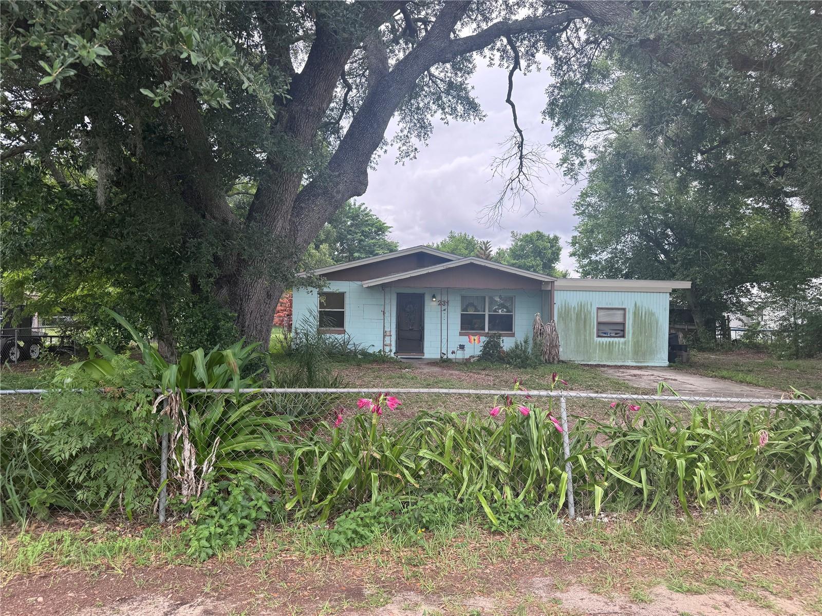 Welcome to 231 Willow Street in Lake Wales! This 3-bedroom, 1.5-bath concrete block home offers flexible living space with an enclosed carport that can serve as a bonus room, home office, hobby space, or potential 4th bedroom. The fully fenced property provides plenty of outdoor space with no HOA restrictions.

Inside, you'll find an eat-in kitchen and dining area, along with original 1970 tile flooring that adds unique character and vintage appeal. The kitchen appliances, including the refrigerator, range, microwave, and recently replaced dishwasher (less than 6 months old), are included, as well as the washer and dryer. Several important updates have already been completed, including a new electrical panel, new blown-in attic insulation for improved energy efficiency and comfort, an updated well bladder, and an updated drain field. The A/C unit was replaced in 2017.

Outside features include a separate utility room, mature shade trees, and a backyard with producing navel orange, red navel orange, lemon, and peach trees. Pineapple plants are growing in the front yard, adding to the property's Florida charm. A 30-amp electrical hookup in the backyard offers added convenience for a generator or RV.

This home offers an excellent opportunity for cosmetic updates and personal touches, allowing the next owner to enhance both the appearance and value of the property. Priced to sell at $199,000, the seller has factored the home's need for updating into the asking price while already completing several key system improvements. The property is being sold AS-IS, and the seller will not make repairs. This presents a compelling value with room for future improvement and equity potential. Conveniently located near local amenities, this home may appeal to owner-occupants and investors alike. Seller is highly motivated and seeking a quick sale—bring your offers!