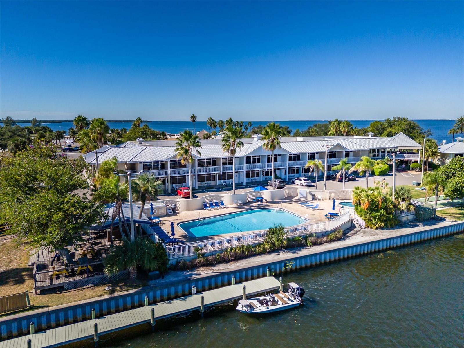 Waterfront Studio with Resort Amenities & Proven Rental Income in Little Harbor.  Capture your piece of paradise with this charming, fully furnished, accessible, waterfront studio condo located in the highly sought-after Little Harbor community in Ruskin. Whether you’re an investor seeking reliable rental income or a buyer looking for a hassle-free second home, this turnkey property checks every box. The current owners have enjoyed a strong rental history, making this an excellent income-producing opportunity from day one.  Step inside this bright and inviting open studio featuring two queen-sized beds, efficient kitchenette perfect for light meals and snacks and large windows that fill the space with natural light and serene water views. Wake up each morning to peaceful waterfront scenery and unwind in the evenings with breathtaking sunset views.  Little Harbor redefines coastal living with an incredible array of amenities just steps from your door:  Two heated community pools, private sandy beach for swimming and sunbathing, beachfront tiki bar with live music and sunset views, popular on-site restaurants offering waterfront dining, pickleball and tennis courts, fitness center and playground, deep-water marinas with direct access to Tampa Bay and the Gulf of Mexico, nearby Freedom Boat Club for convenient boat rentals, kayaking, paddleboarding, canoeing, and other water activities within the community.  Enjoy watching boats cruise by, spotting marine life, and experiencing the relaxed coastal lifestyle that makes this community so desirable among residents and vacationers alike.  
Conveniently located just minutes from Interstate 75, this Ruskin gem offers quick access to Tampa and the Gulf beaches.
Monthly fees include: Water, Electric, Parking, Cable, Internet, Insurance, Exterior Maintenance, and Full access to all community amenities.
Whether you’re investing, vacationing, or seeking a 2nd home, this well-maintained studio offers exceptional value in a premier resort setting.  
Don’t miss your opportunity to own a turnkey waterfront retreat with outstanding income potential. Schedule your private showing today and start living the Little Harbor lifestyle!