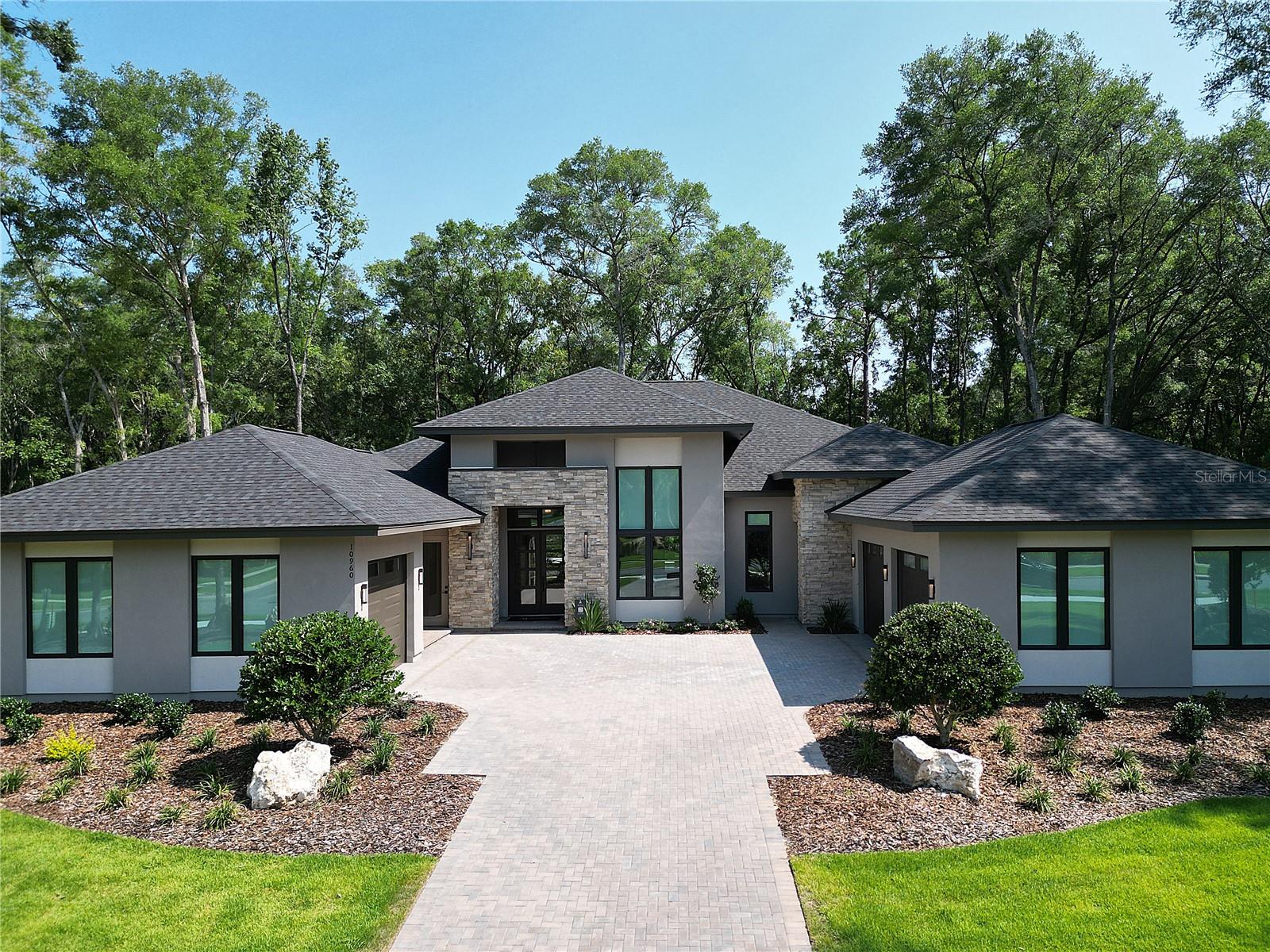 Pre-Construction. To be built. The Vizcaya, a transitional luxury residence to be built by AR Homes. Ideally positioned on an east-facing one-acre homesite in Oakmont. This single-story home offers 4,161 square feet of thoughtfully designed living space, including 4 bedrooms, 3.5 baths, a private den, and a Spacious Bonus/Flex Room. A dramatic 14-foot foyer introduces clean architectural lines, warm modern finishes, and expansive walls of glass that define the home’s light-filled interiors. The great room features custom floating wood shelves and seamlessly connects to the outdoor living area, where sliding glass doors open to a covered lanai and cabana—perfect for effortless indoor-outdoor entertaining. The gourmet kitchen and dining area are highlighted by a soaring 14-foot vaulted ceiling with stained wood beams and anchored by a showpiece kitchen featuring a 48" commercial range, 48" refrigerator, stone countertops, oversized island custom wood cabinetry including custom vent hood surround. A separate prep kitchen with a 2nd refrigerator, 2nd dishwasher and prep sink enhances both functionality and entertaining. Privately situated, the owner’s suite occupies its own wing and features refined architectural details, a spacious walk-through closet with direct laundry access, and a spa-inspired bath with freestanding tub, expansive glass-enclosed shower, and designer finishes. A standout feature is the attached VIP guest suite with private entrance and garage, offering a studio-style layout with kitchenette, walk-in closet, and en-suite bath—ideal for guests or multigenerational living. Additional highlights include a dedicated den with 14-foot ceilings and floor-to-ceiling windows, as well as a centrally located wet bar designed for entertaining. A rare opportunity to secure the final buildable one-acre homesite in Oakmont, with the ability to personalize and select finishes to suit your style. Located within the sought-after Oakmont community, residents enjoy resort-style amenities across 550 acres, including a clubhouse, fitness center, pool, pickleball and tennis courts, and scenic tree-lined streets.