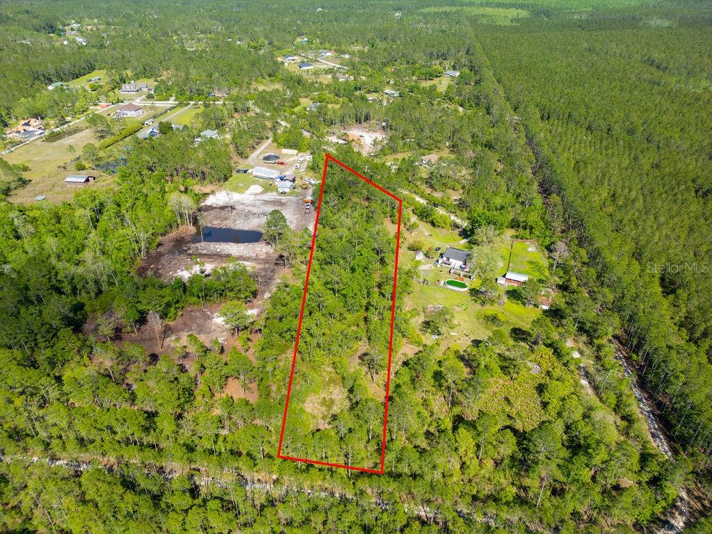 Discover the perfect opportunity to build your dream home in the peaceful Plantation Pines community of Ormond Beach. Nestled on an expansive 3.46-acre parcel, this property offers the ideal blend of privacy and convenience. Tucked away on a quiet dead-end street and surrounded by mature trees and natural Florida beauty, this serene setting creates the perfect backdrop for your custom estate. With ample space to design your ideal lifestyle, there’s plenty of room for a custom home, pool, guest house, workshop, and more. Whether you’re looking for a private retreat or a place to bring all your toys, this oversized lot accommodates boats, RVs, and recreational vehicles with ease—and best of all, HOA is optional. Enjoy the tranquility of country living while being just a short drive to the beach, shopping, dining, schools, and easy access to I-95.