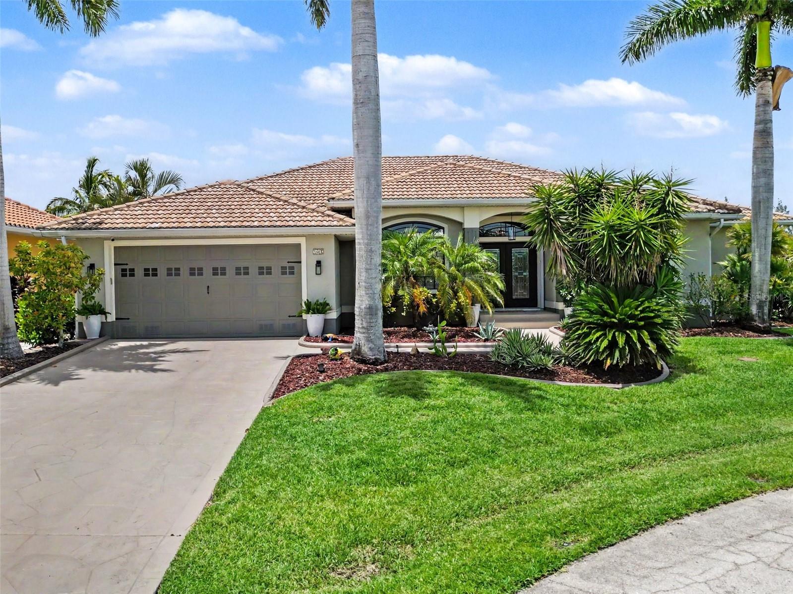Welcome to 1442 Kiwi Ct in the highly desired Punta Gorda Isles, offering direct sailboat access to Charlotte Harbor and an exceptional waterfront lifestyle. Positioned on a cul-de-sac with no HOA, this home features 109 feet of water frontage with a 30-foot dock and a 12,000 lb boat lift, plus water and electric at the dock. A pavered walkway to the dock was built by Beltran, adding both beauty and convenience to your waterfront routine. 

This property offers a secure outdoor environment with a fenced rear yard and an electric fence expanding throughout the entire property. Inside, enjoy high ceilings and an open feel with 3 bedrooms and 2 bathrooms, including 10 ft+ elevation throughout for added peace of mind. The home’s expansive sliding glass doors bring the outdoors in, and the split floor plan provides privacy for both residents and guests.

The gourmet kitchen is equipped with high-end appliances including Kraftsmade soft-close wood cabinets, a Wolfe gas stove, Wolfe Sub-Zero refrigerator, and a double drawer Fisher & Paykel dishwasher and a Manitowoc ice maker. Retreat to the expansive primary suite, where you can enjoy beautiful Florida sunrise views and sliders to the screened lanai.

Outside, relax in your screened oasis featuring an inground heated saltwater pool, piped-in gas line, exhaust fan, and Nautilus electric roll-down hurricane shutters. Additional upgrades include a Kohler whole house generator, a 1,000 lb propane tank, water purification system, reverse osmosis, water softener, and a 30-amp RV plug.

This home comes with a transferrable flood policy.

Boat to Charlotte Harbor in approximately 10–15 minutes, making every day feel like vacation. With its ideal boating access, privacy, and thoughtful upgrades throughout, this home offers everything you want for your Florida waterfront lifestyle.