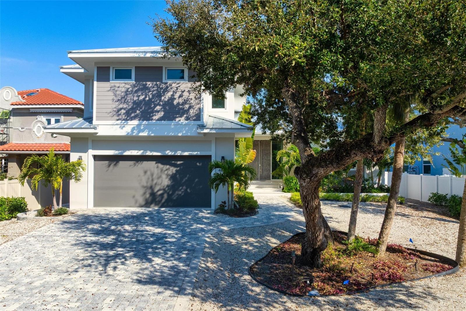 Virtually Staged. New Construction. Come see this coastal Siesta Key home located on the Grand Canal.  The home is located on prime waterfront property with the best views of the Grand Canal, which provides easy access to the bay.  A boater's dream!  This three-level waterfront property offers the best in luxurious living, with four spacious bedrooms and four full baths and two half baths. Step inside the impressive front doors into the bright foyer which leads to the spacious great room, well-planned kitchen and bonus and/or dining room.  Take in the beautiful wide views of the Grand Canal from your gorgeous pool, spa and travertine deck or while cooking from your outdoor kitchen.  The first floor also features the primary bedroom, powder bath, and laundry room.  The beauty of the home is the open concept living area which allows for natural light to flow from large windows and slider throughout the space.  Located on the second floor are the second and third bedrooms each with their en suite bathroom.  On the third floor, you will find another master suite where you can enjoy more waterfront views from its balcony.  Enjoy your private den or office with walk in closet and mechanical storage closet.  This home is situated in a prime location, just moments away from the world-famous Siesta Key Beach, known for its pristine beaches and clear waters. Close enough to famous Siesta Key Village but still out of the hustle and bustle. Also this home is in walking distance to The Out of Door Academy.  Explore local dining and shopping or enjoy all the activities that Siesta Key living provides, fishing, boating, kayaking, walking, biking.  You can even golf cart to the Siesta Key Village.  Come see for yourself, this brand new residence and feel the Siesta Key life style.  This is an exceptional custom home with well appointed extra features that will give you the best, easiest coastal living in Sarasota.  Don't miss out on this home!  Some photos virtually staged.